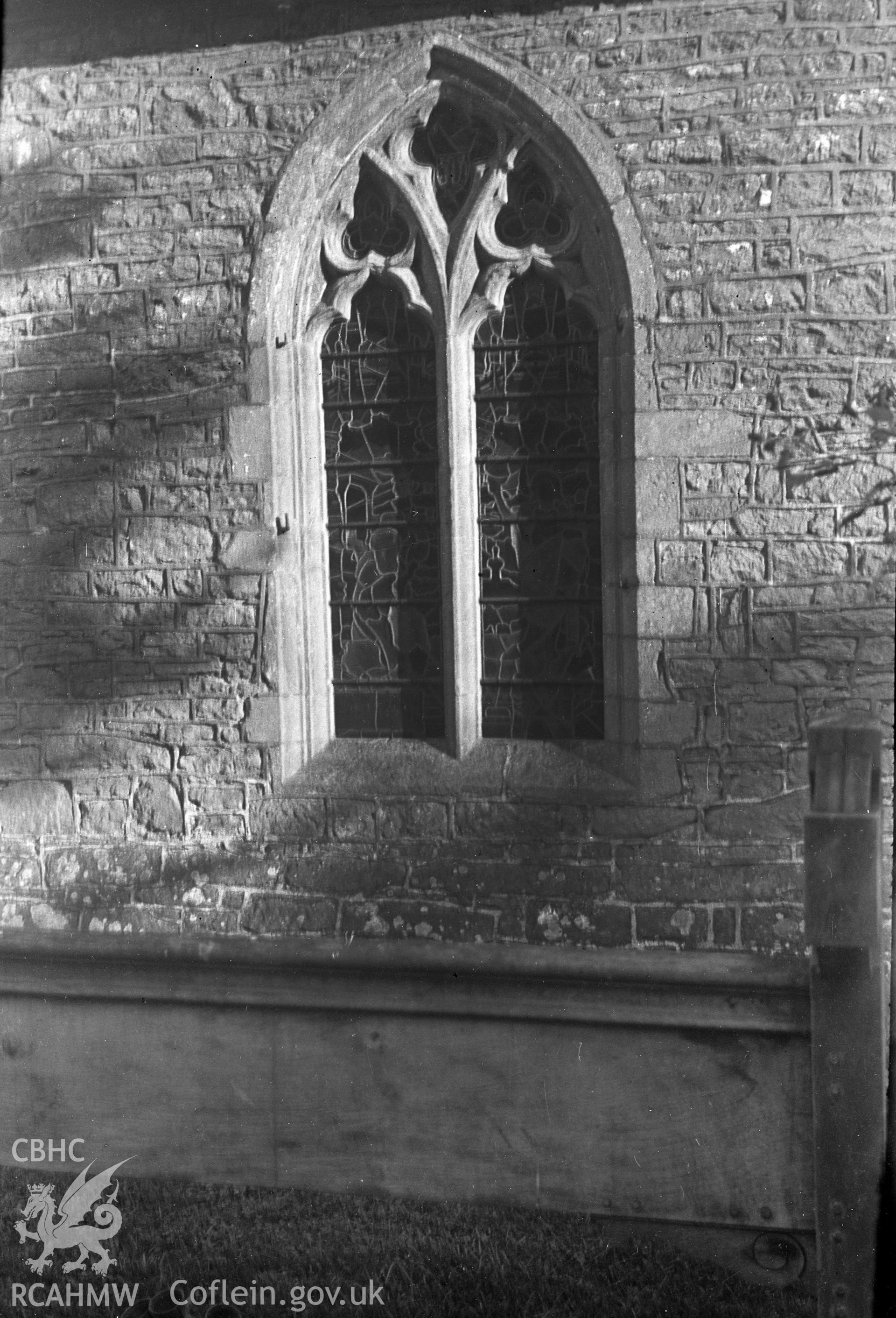 Digital copy of a nitrate negative showing detailed view of exterior window of Church at Skenfrith, taken by Leonard Monroe.