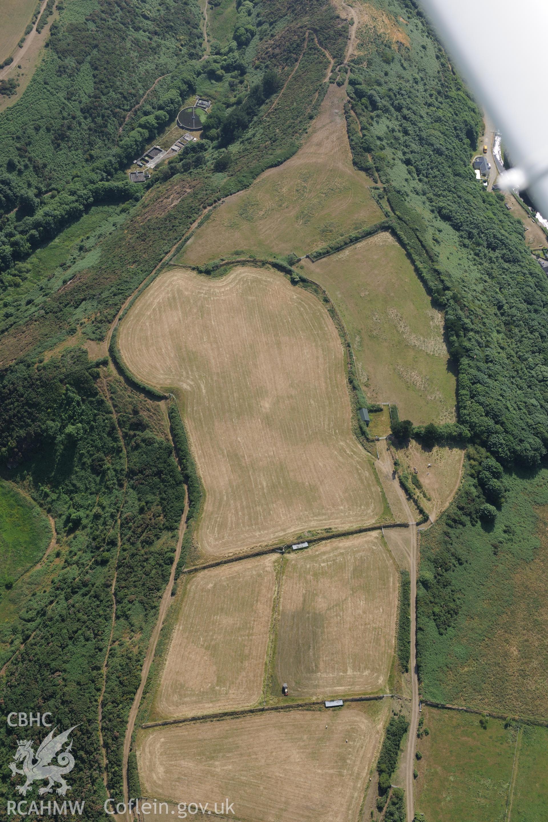 Defended enclosure at Solva. Oblique aerial photograph taken during the Royal Commission?s programme of archaeological aerial reconnaissance by Toby Driver on 16th July 2013.