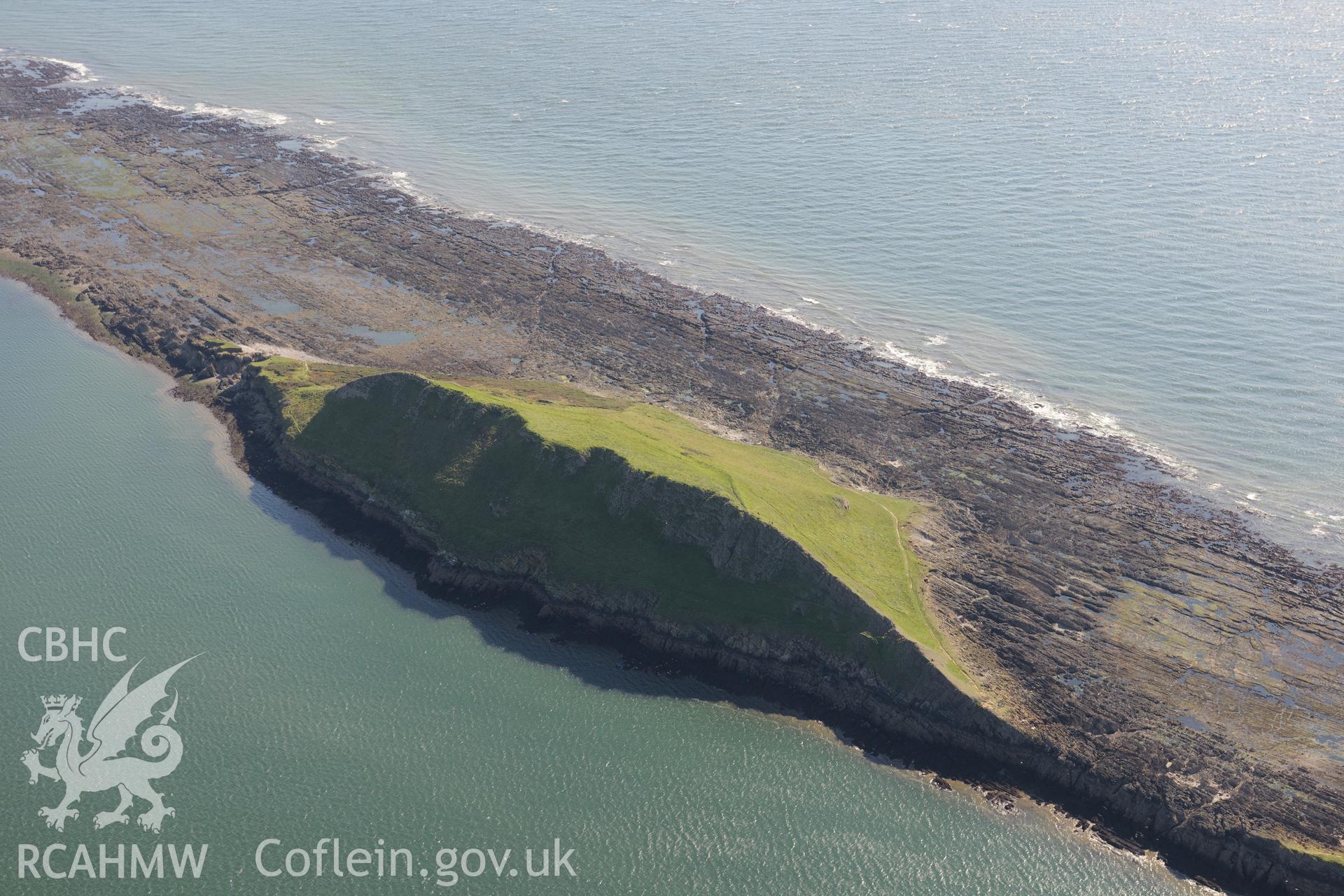 Worm's Head and the enclosure on its north eastern side, near Rhossili, on the western coast of the Gower Peninsula. Oblique aerial photograph taken during the Royal Commission's programme of archaeological aerial reconnaissance by Toby Driver on 30th September 2015.