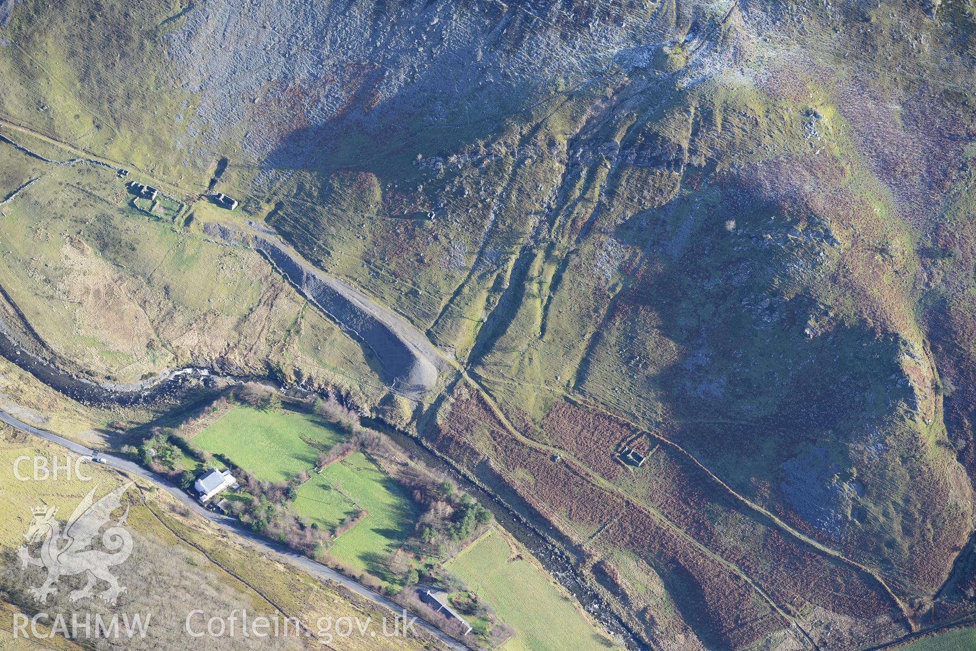 Henbarc mine office,cottage, dwelling & pigsty; Tan-y-chwarel house & a spoil heap at Cwmystwyth Lead Mine. Oblique aerial photograph taken during the Royal Commission's programme of archaeological aerial reconnaissance by Toby Driver, 4th February 2015.