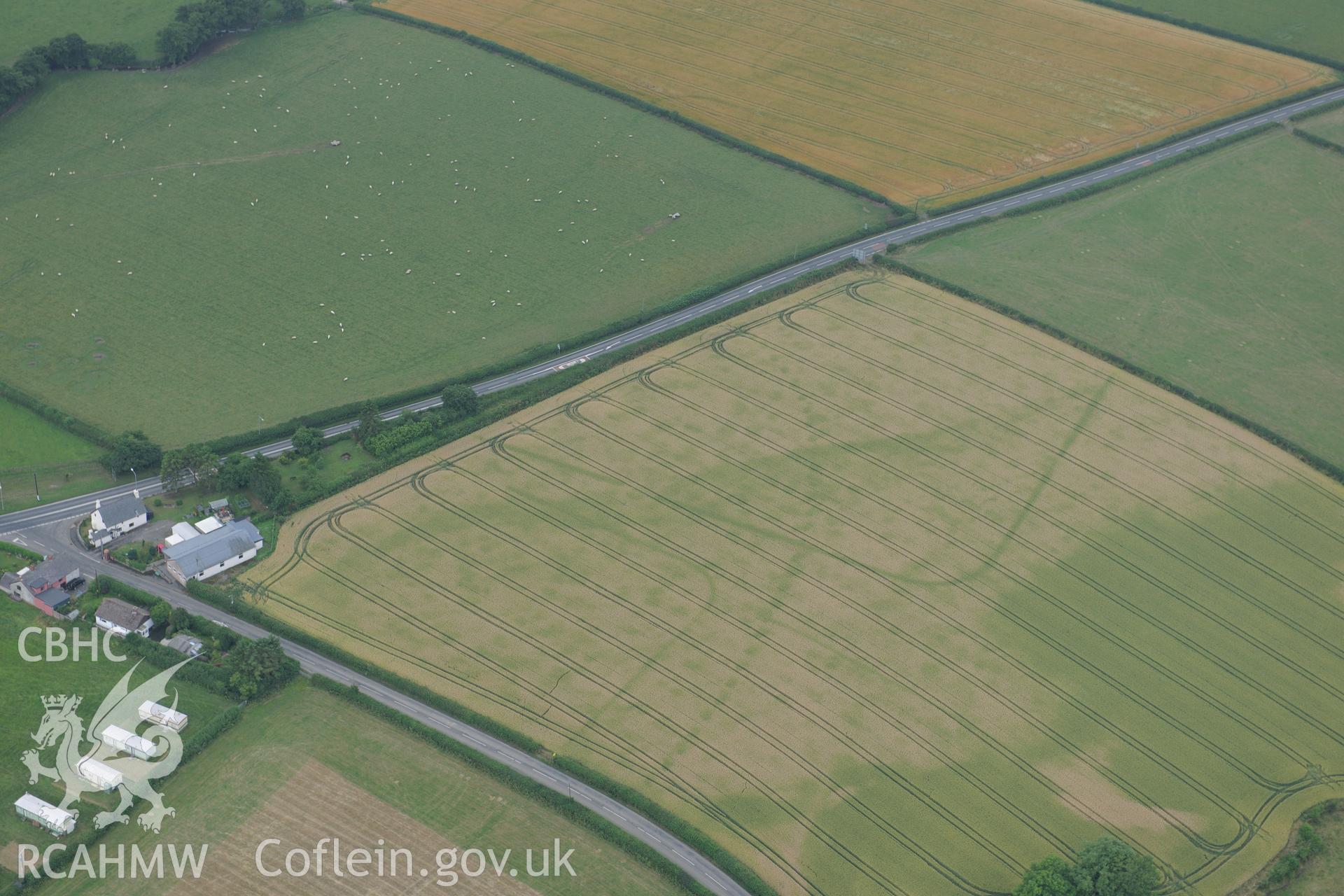 Walton palisaded enclosure and Roman camp, east of Llandrindod Wells, near the Wales-England border. Oblique aerial photograph taken during the Royal Commission?s programme of archaeological aerial reconnaissance by Toby Driver on 1st August 2013.