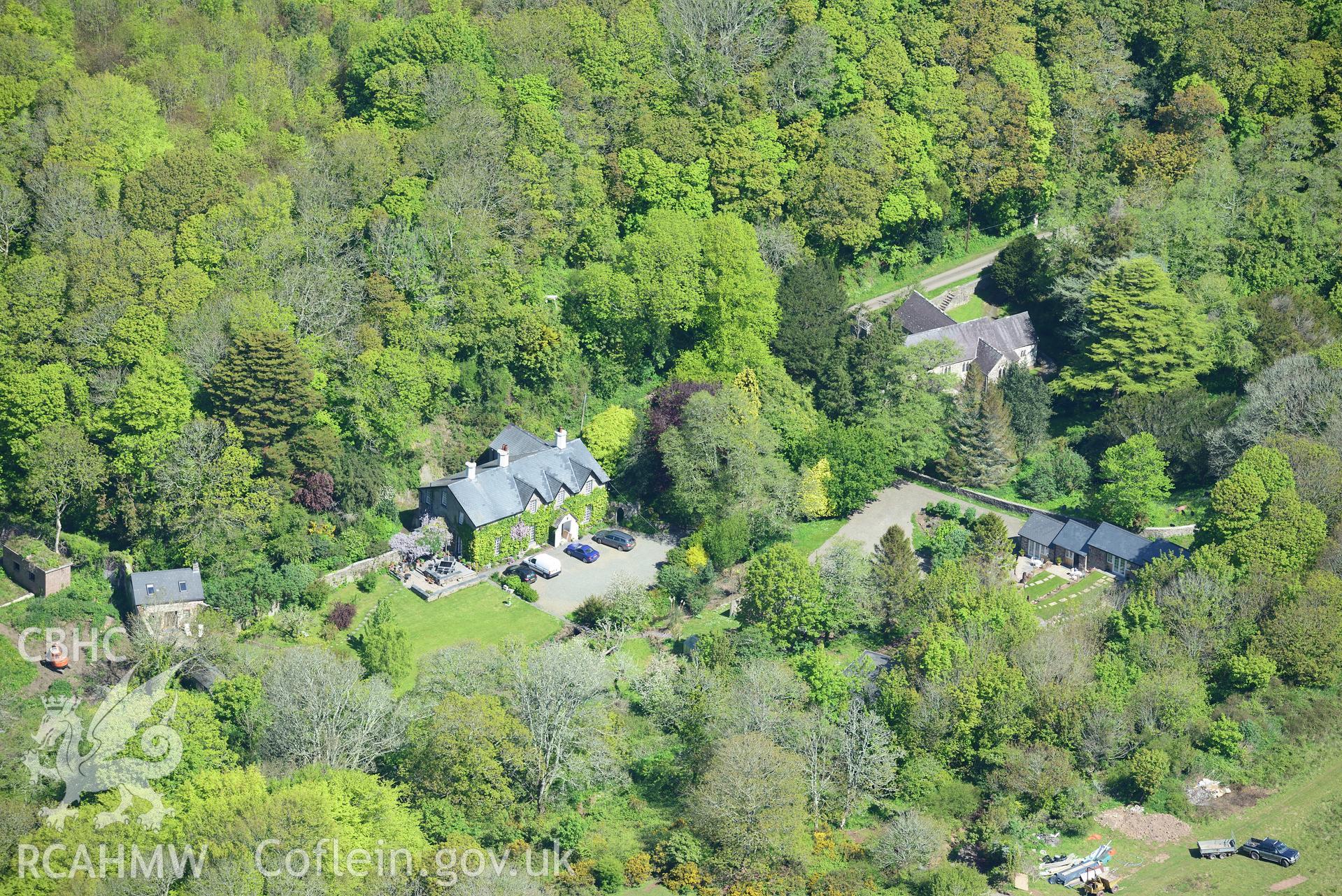 St. Ishmael's parish church and vicarage, now Monk Haven Manor. Oblique aerial photograph taken during the Royal Commission's programme of archaeological aerial reconnaissance by Toby Driver on 13th May 2015.