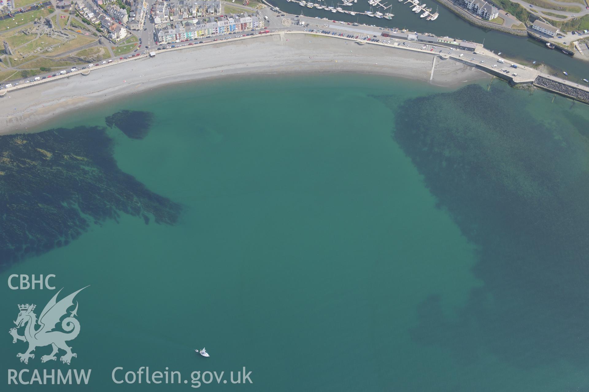 The town of Aberystwyth, including views of the castle, harbour and south beach. Oblique aerial photograph taken during the Royal Commission?s programme of archaeological aerial reconnaissance by Toby Driver on 12 July 2013.