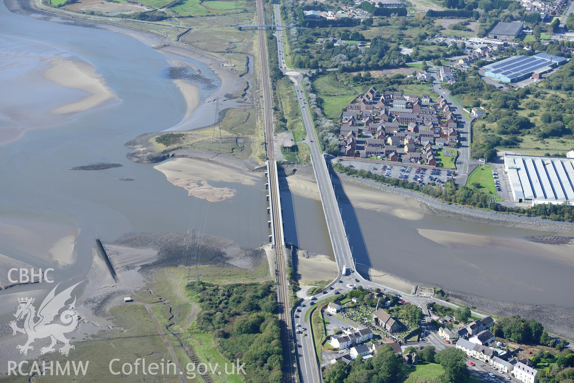 St. Michael's church and Loughor Castle; railway viaduct; road bridge; Roman Fort and Yspytty tin plate works, Loughor, between Llanelli and Swansea. Oblique aerial photograph taken during the Royal Commission's programme of archaeological aerial reconnaissance by Toby Driver on 30th September 2015.