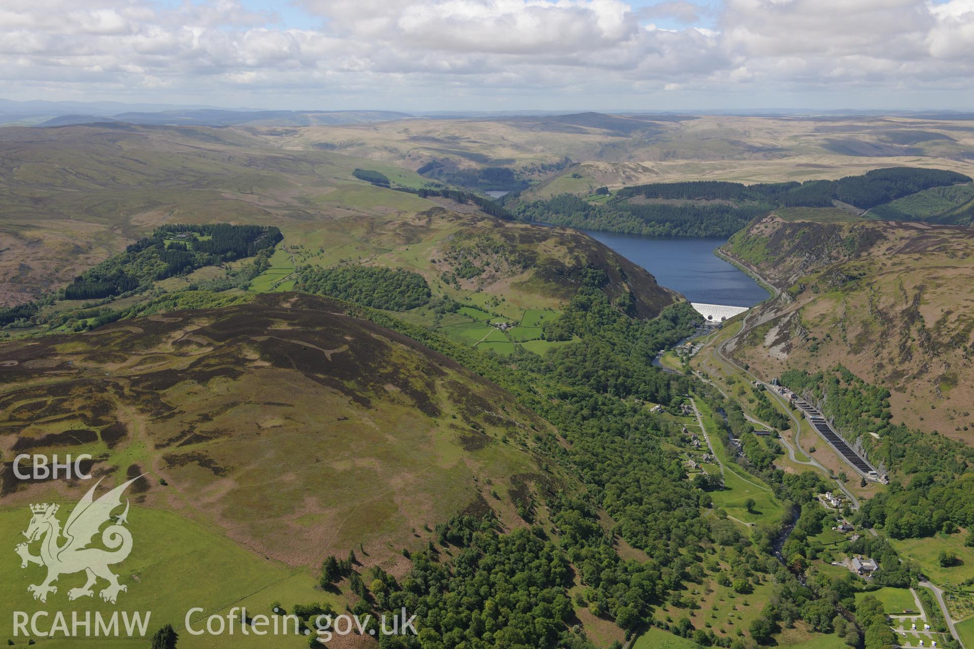 Landscape view of Caban Coch reservoir, dam and Elan Village, Birmingham Corporation Waterworks model village. Oblique aerial photograph taken during the Royal Commission?s programme of archaeological aerial reconnaissance by Toby Driver on 3rd June 2015.