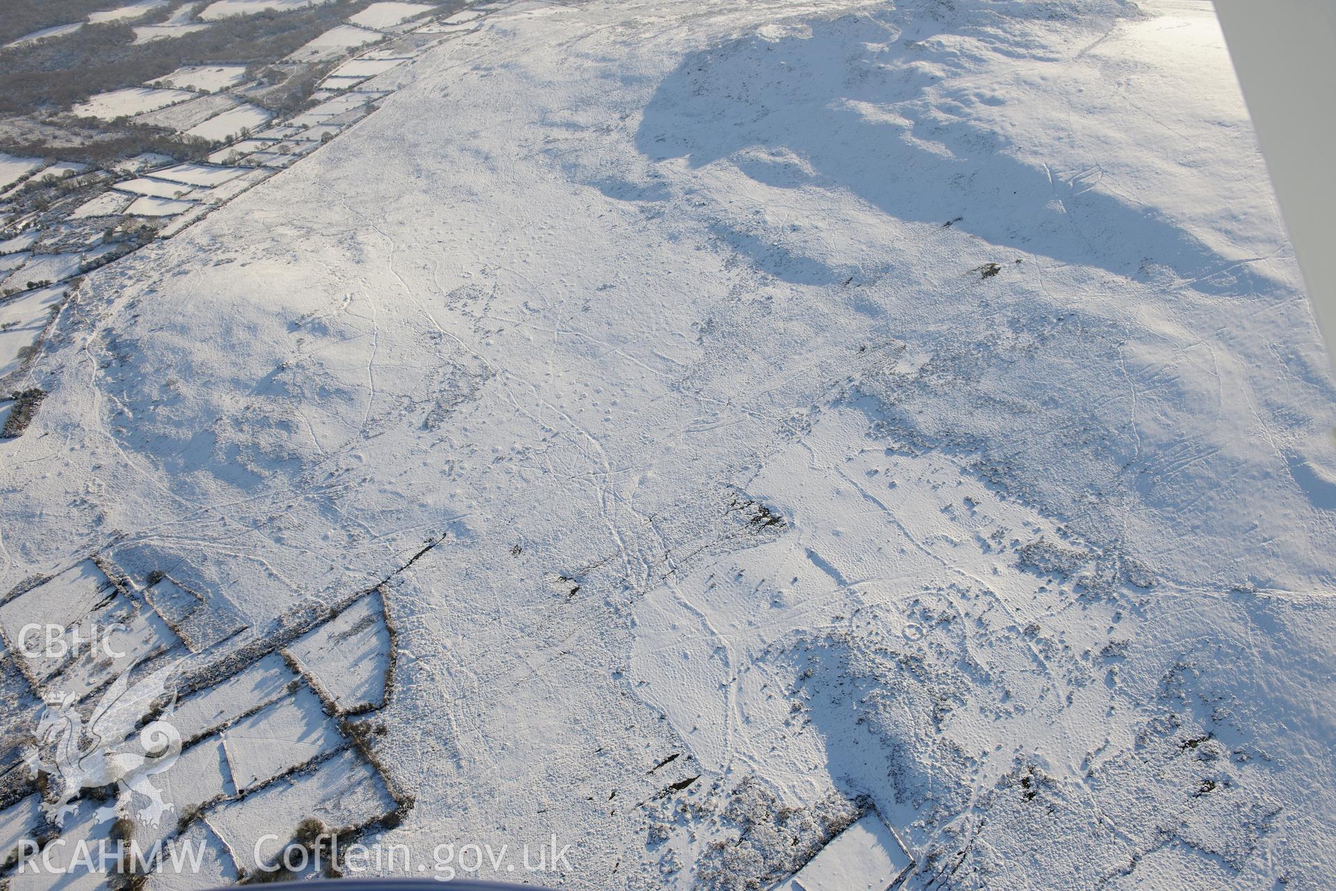 Carn Llwyd earthwork, Mynydd Carn Ingli. Oblique aerial photograph taken during the Royal Commission?s programme of archaeological aerial reconnaissance by Toby Driver on 24th January 2013.