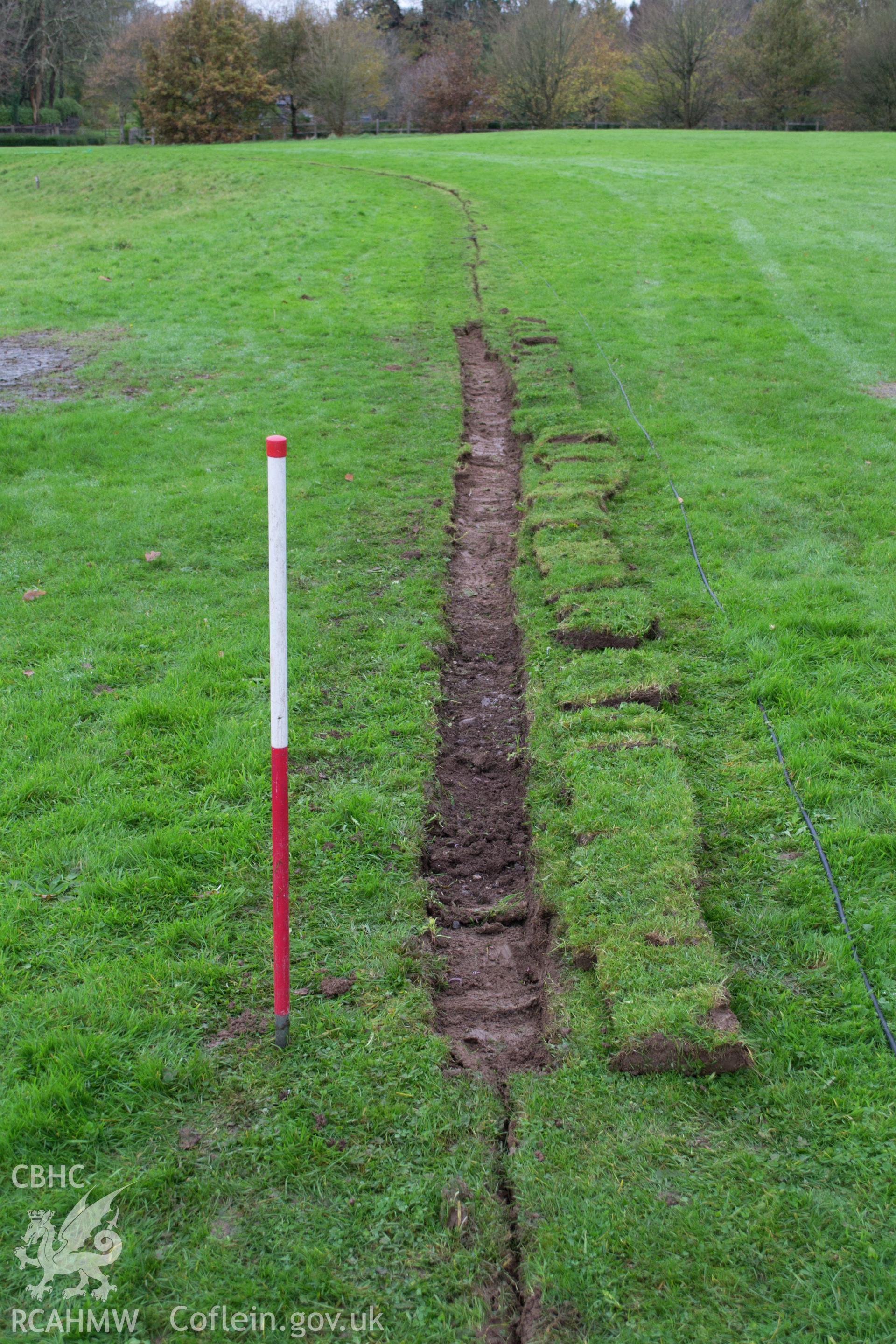 Detailed view from east of 0.3m trench cut, showing service trench cut. Photographed during archaeological watching brief of Plas Newydd, Ynys Mon, conducted by Gwynedd Archaeological Trust on 14th November 2017. Project no. 2542.