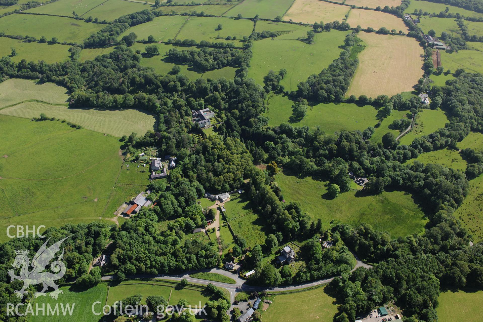 Plas Boduan surrounded by its park and gardens with St. Buan's church visible to the south. Oblique aerial photograph taken during the Royal Commission's programme of archaeological aerial reconnaissance by Toby Driver on 23rd June 2015.