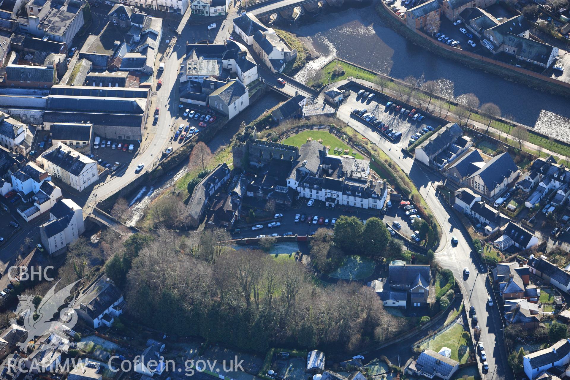 Brecon Castle and the Castle of Brecon Hotel. Oblique aerial photograph taken during the Royal Commission?s programme of archaeological aerial reconnaissance by Toby Driver on 15th January 2013.