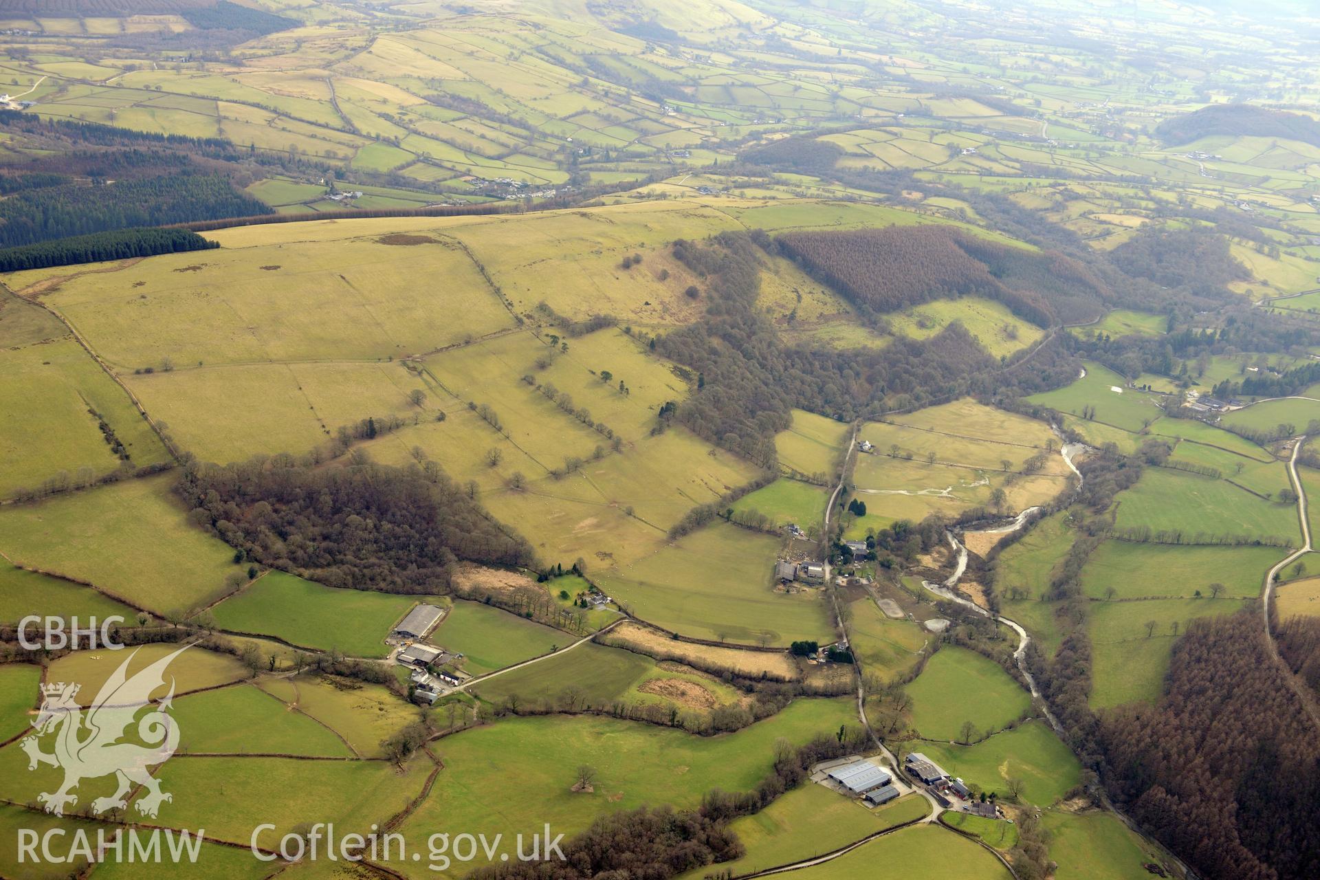 View looking south west at the Cothi Valley, with Allt-y-Brunant Roman water tank visible. Oblique aerial photograph taken during the Royal Commission?s programme of archaeological aerial reconnaissance by Toby Driver on 28th February 2013.