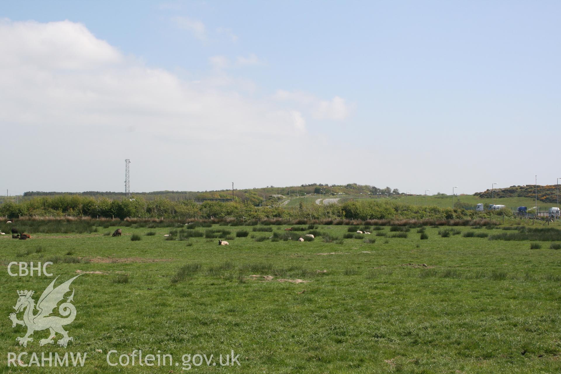 View from development site towards Trefignath Chambered Tomb. Looking southeast. Digital photograph taken as part of archaeological work at Parc Cybi Enterprise Zone, Holyhead, Anglesey, carried out by Archaeology Wales, 2017. Project number: P2522.