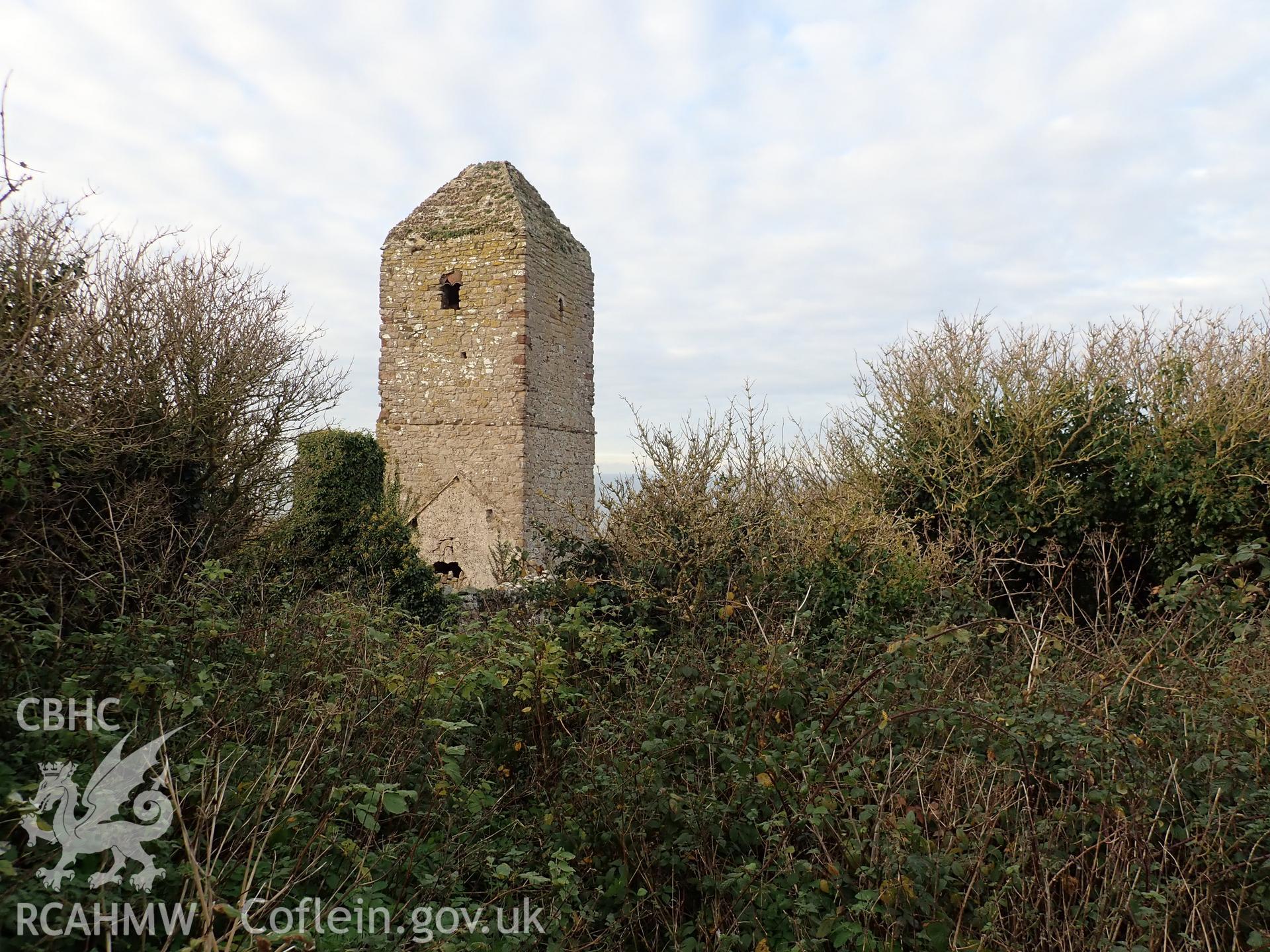 Investigator's photographic survey of the church on Puffin Island or Ynys Seiriol for the CHERISH Project. Winter view of church tower from south-east, showing overgrown environs. ? Crown: CHERISH PROJECT 2018. Produced with EU funds through the Ireland Wales Co-operation Programme 2014-2020. All material made freely available through the Open Government Licence.