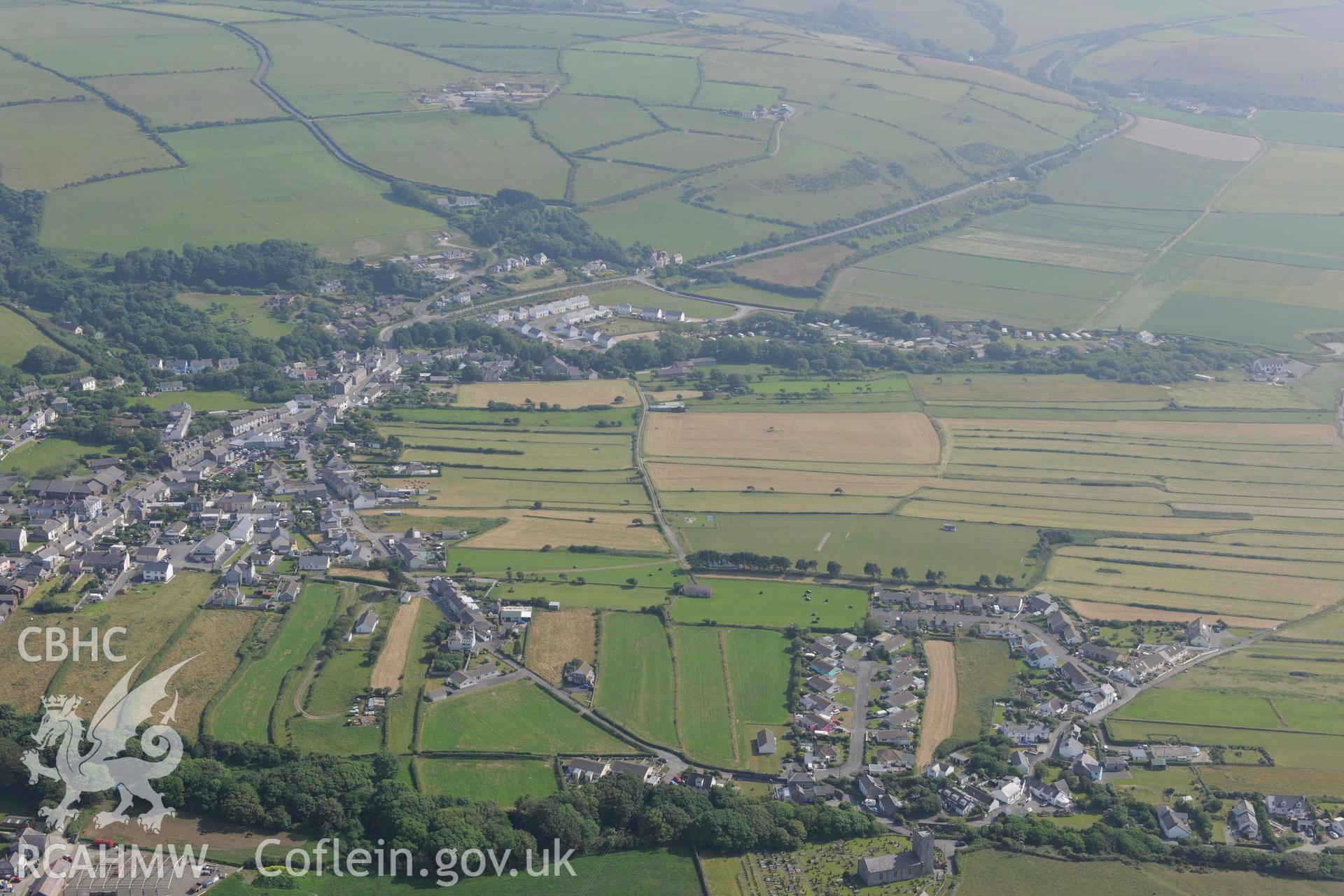 The village of Llanon, Ceredigion, including view of Llanon field system. Oblique aerial photograph taken during the Royal Commission?s programme of archaeological aerial reconnaissance by Toby Driver on 12th July 2013.