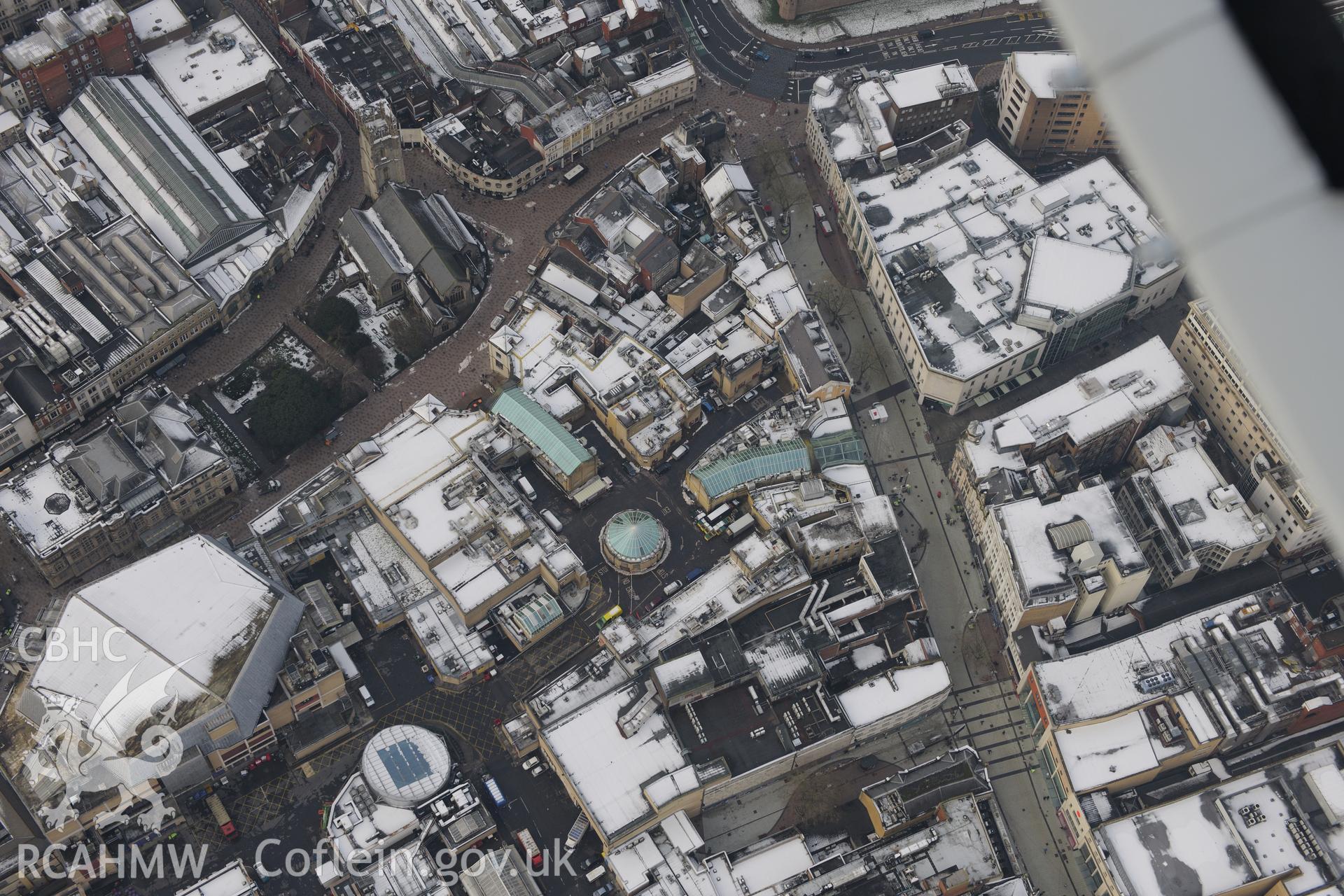 Cardiff central library, St John the Baptist church and St David's shopping centre, Cardiff. Oblique aerial photograph taken during the Royal Commission?s programme of archaeological aerial reconnaissance by Toby Driver on 24th January 2013.