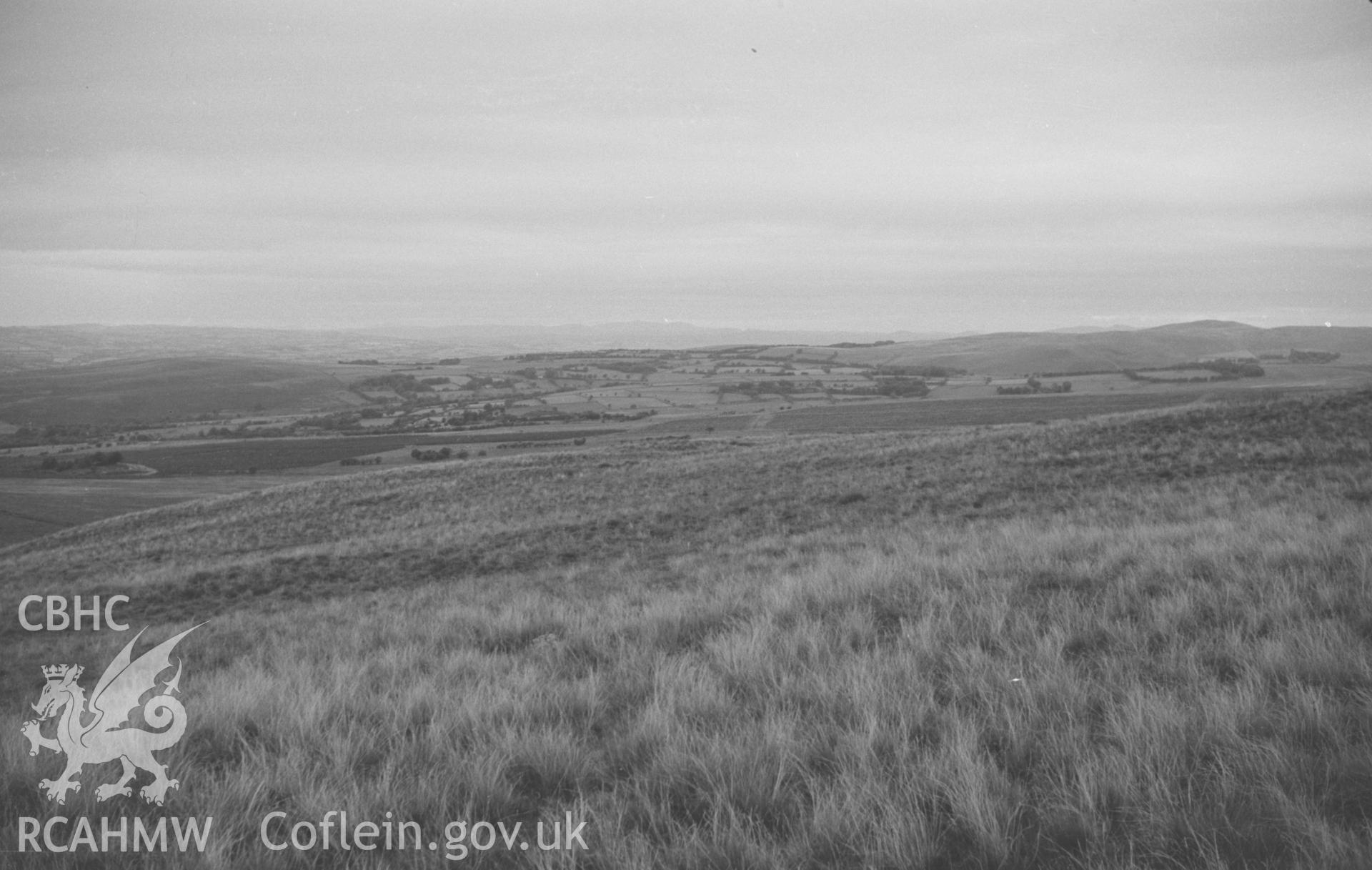 Digital copy of a black and white negative showing view along the course of Sarn Helen from Esgair Fraith cairn field, east of Lampeter. Photographed by Arthur O. Chater in August 1965 from Grid Reference SN 6481 4823, looking north north west.