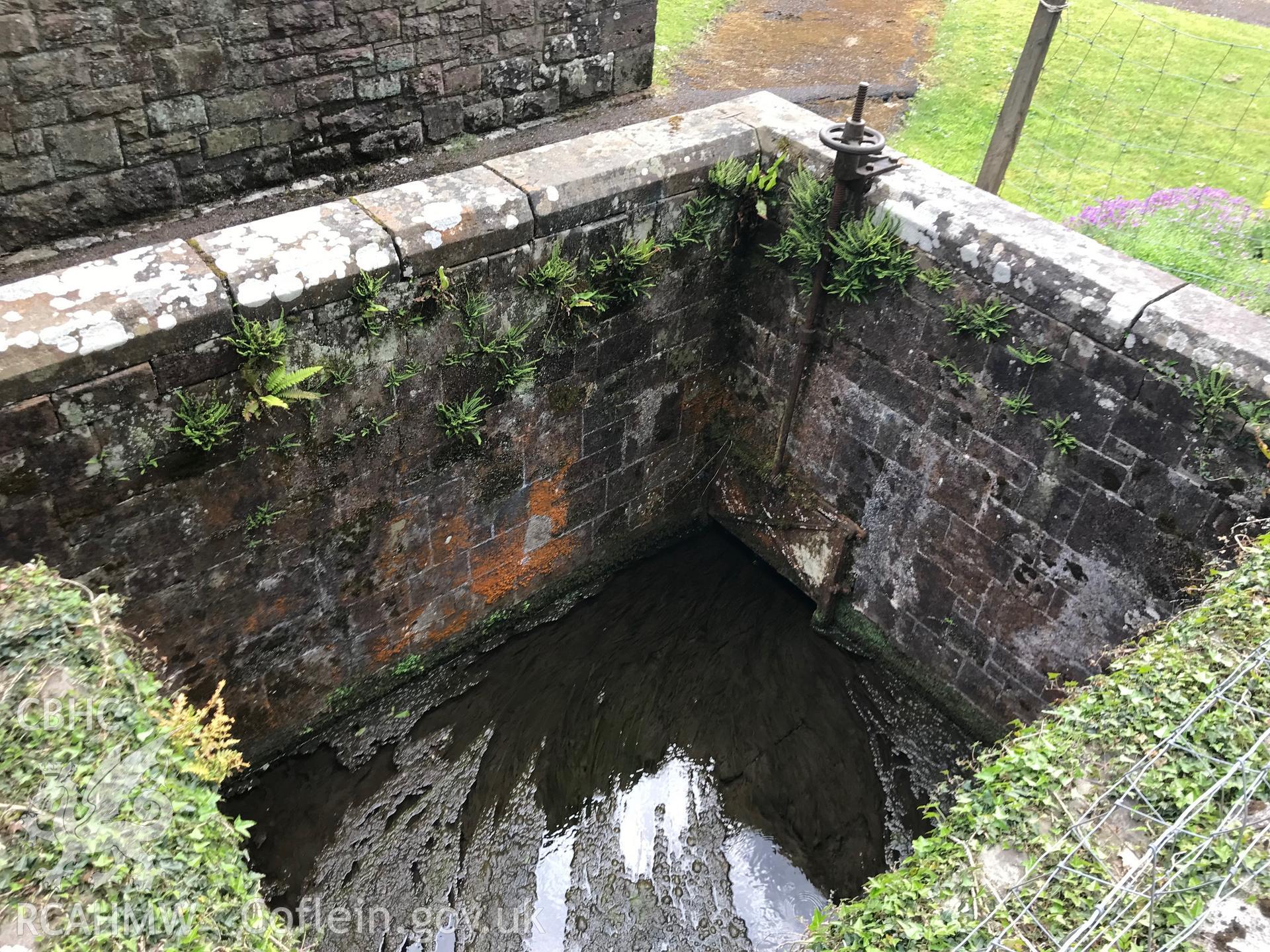 Digital colour photograph showing St Dyfan's well at St Dyfan's Church, Llandyfan, taken by Paul R. Davis on 7th May 2019.