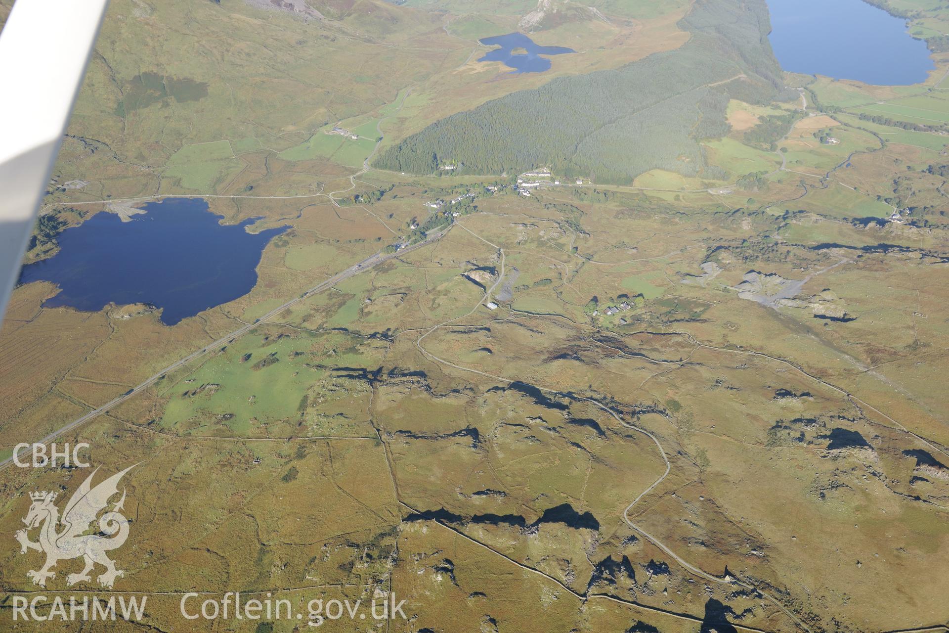 View looking south at Llyn y Cader with Llyn y Dywarchen, Beddgelert forest, and the village of Rhyd-du beyond. Oblique aerial photograph taken during the Royal Commission's programme of archaeological aerial reconnaissance by Toby Driver on 2/10/2015.