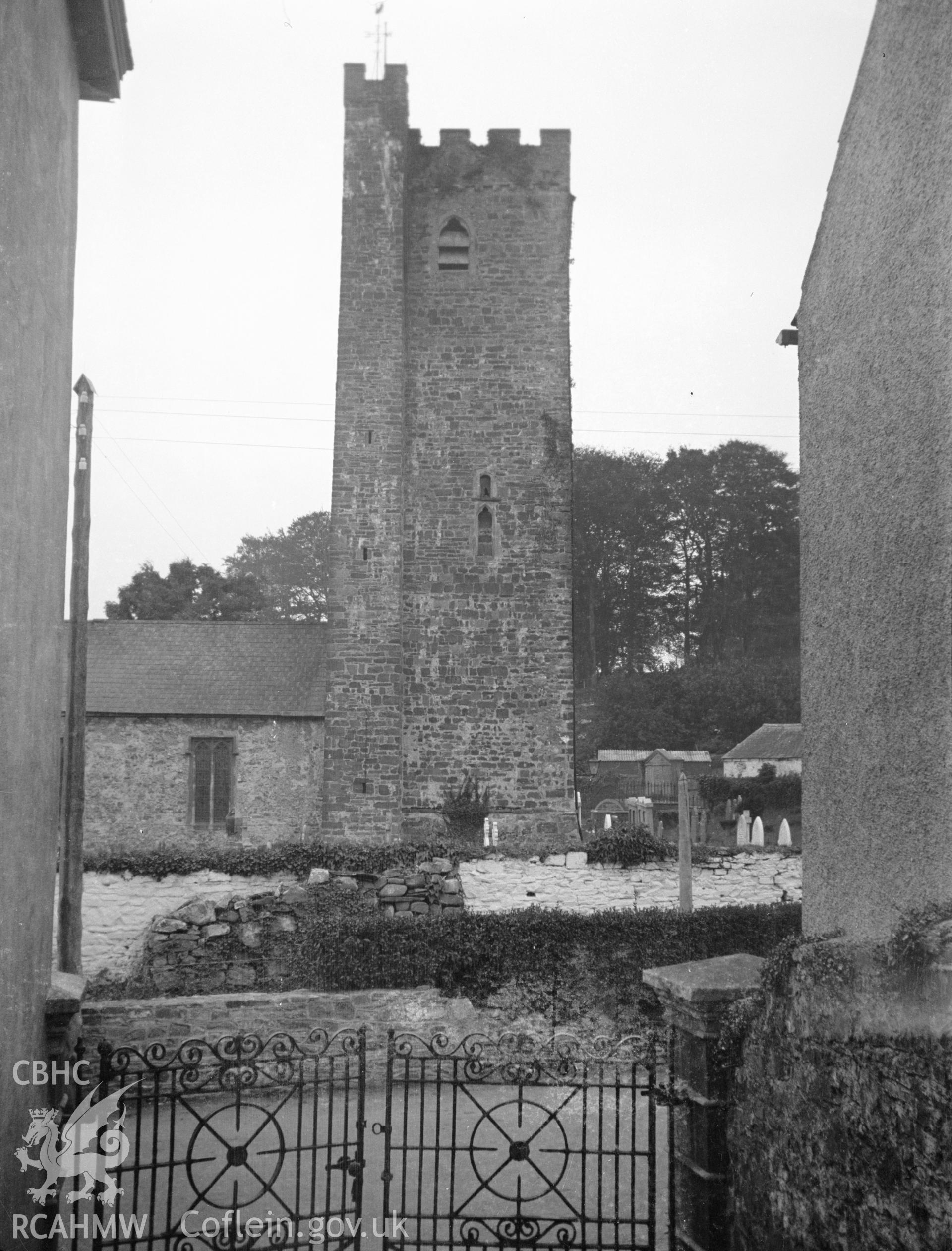 Digital copy of a nitrate negative showing exterior view of tower and white washed graveyard wall of St Stephen's Church, Llanstephan. From the National Building Record Postcard Collection.