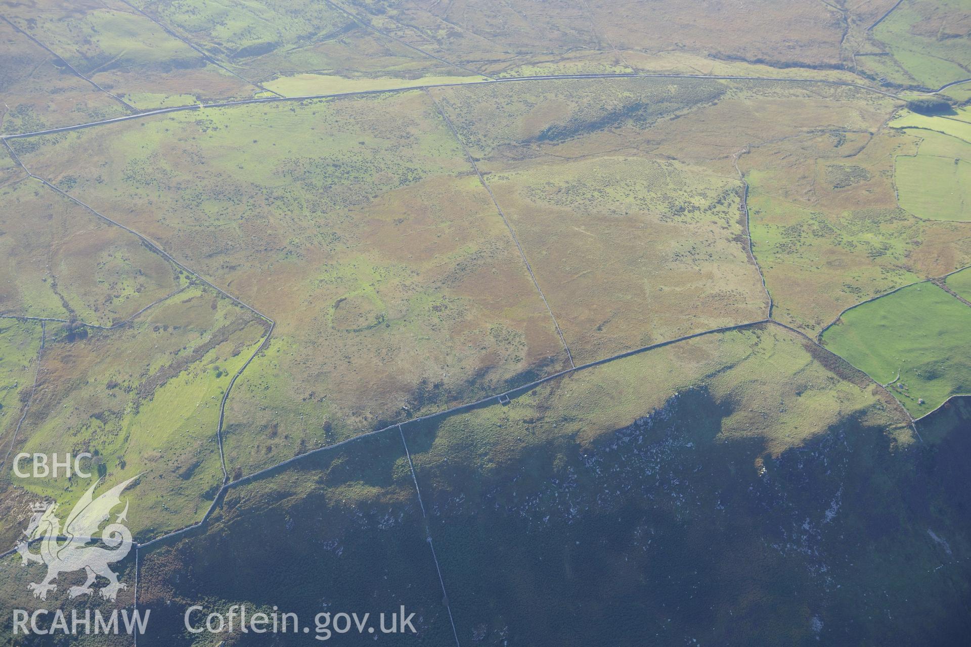 An enclosure at Morfa and hut circles south east of Mynydd Craig Wen, near Fairbourne. Oblique aerial photograph taken during the Royal Commission's programme of archaeological aerial reconnaissance by Toby Driver on 2nd October 2015.