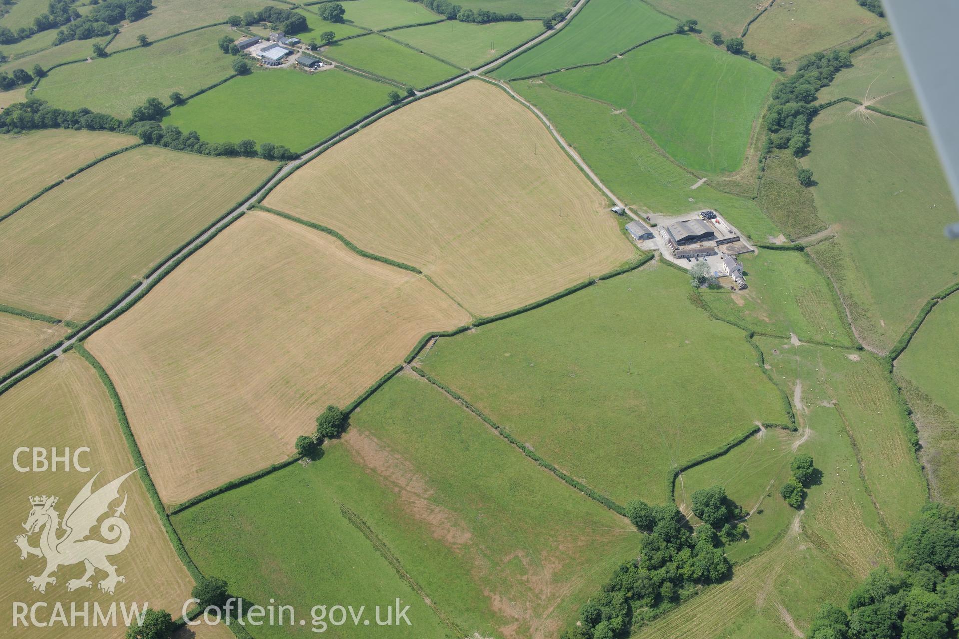 Cropmark enclosure south of Blaen-Lliwe, north west of Whitland. Oblique aerial photograph taken during the Royal Commission?s programme of archaeological aerial reconnaissance by Toby Driver on 16th July 2013.