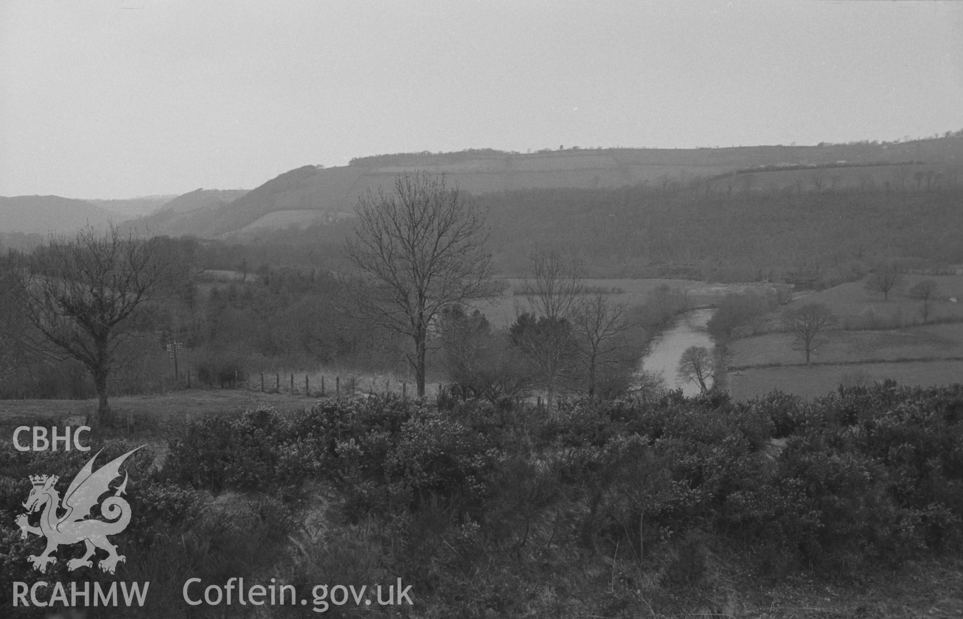 Digital copy of a black and white negative showing panoramic view looking north west over the 3-bank, 2-ditched Castell Pyr promontory fort earthworks. Glanrhydypysgod farm opposite. Photograph by Arthur O. Chater, April 1967. SN 470400. Photograph 4 of 4.