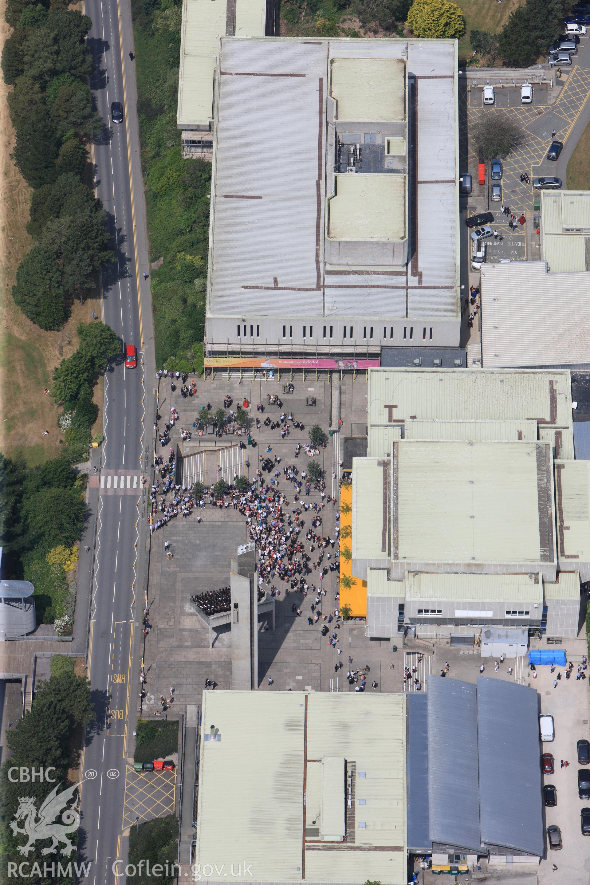 Aberystwyth Arts Centre on Graduation Day. Oblique aerial photograph taken during the Royal Commission?s programme of archaeological aerial reconnaissance by Toby Driver on  12th July 2013.