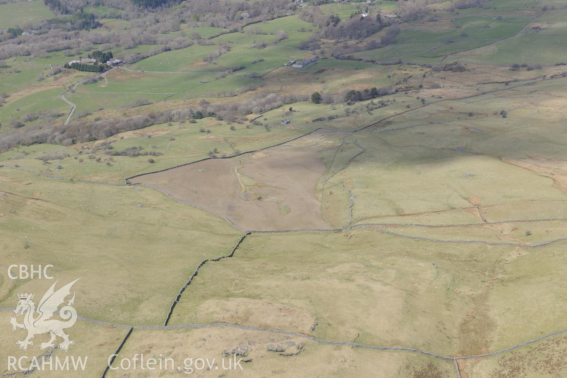 Ffridd Fedw round hut, enclosure, ancient field and kerb cairn, and Tyddyn Sion Wyn ring cairn, Talsarnau, north east of Harlech. Oblique aerial photograph taken during the Royal Commission?s programme of archaeological aerial reconnaissance by Toby Driver on 1st May 2013.