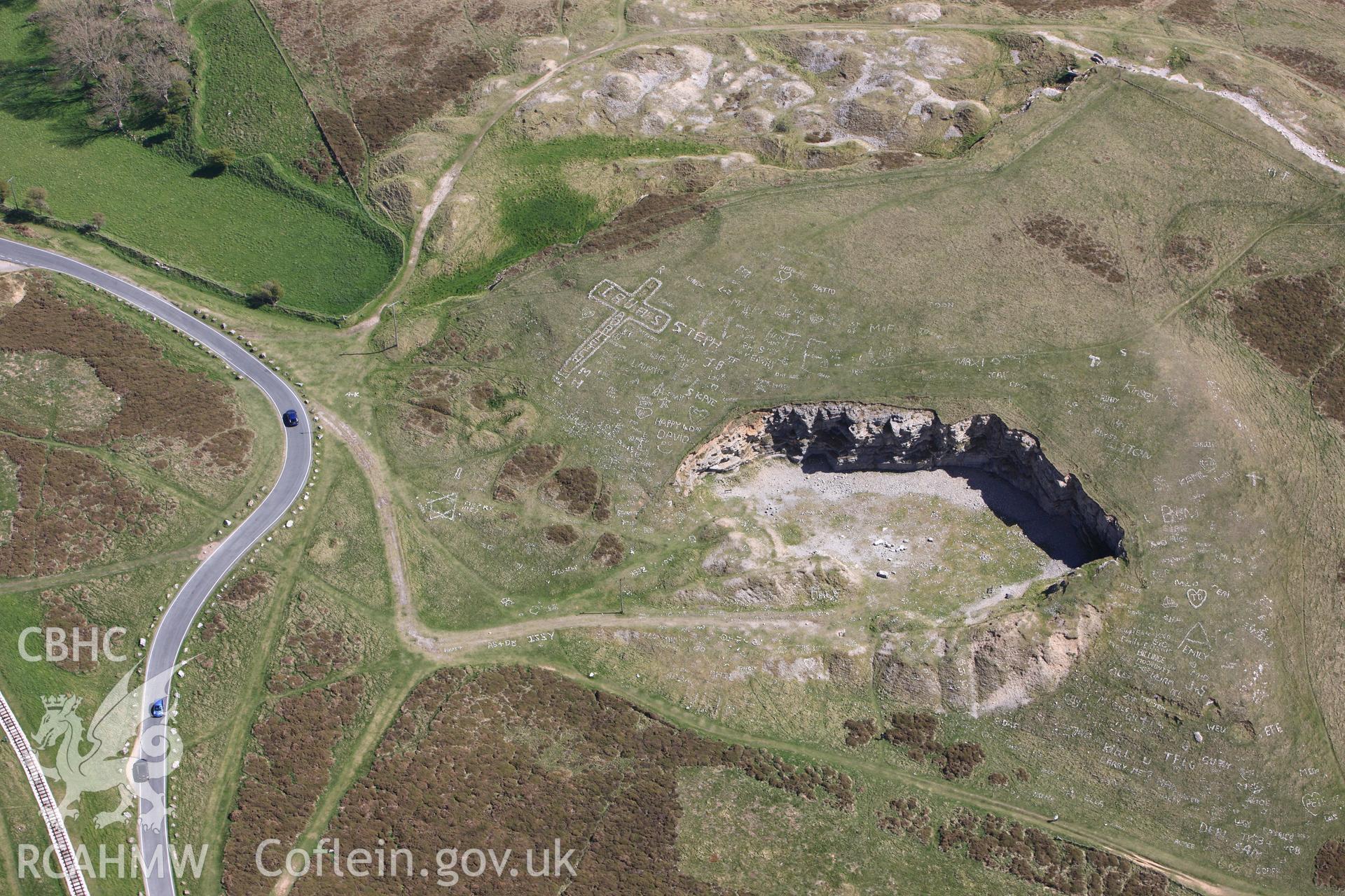 Bishop's quarry, Great Orme, with hillside graffiti above, Llandudno. Oblique aerial photograph taken during the Royal Commission?s programme of archaeological aerial reconnaissance by Toby Driver on 22nd May 2013.