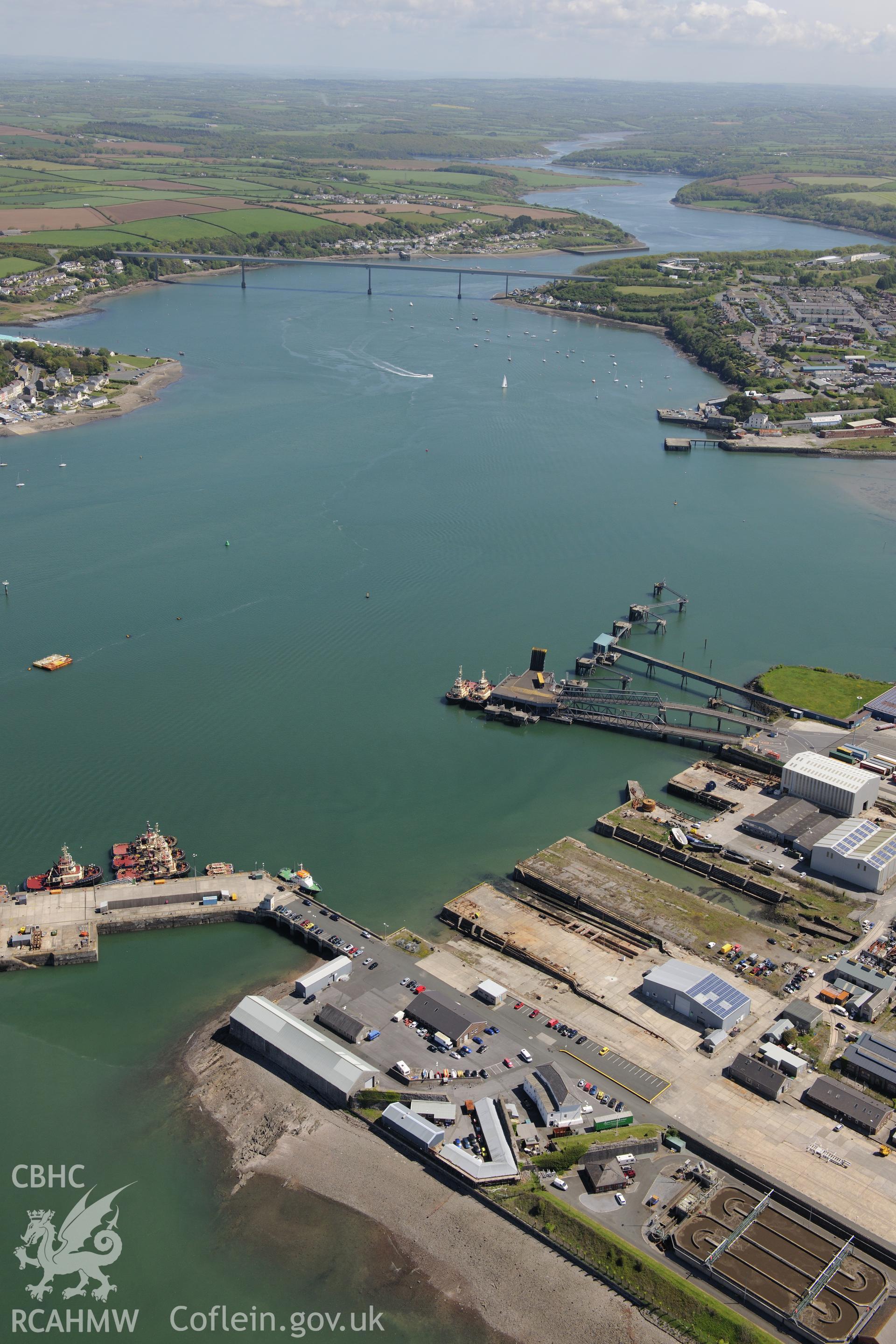 Pembroke Royal Dockyard and the dry dock at Pembroke Dockyard, and the ferry terminal at Pembroke Dock. Oblique aerial photograph taken during the Royal Commission's programme of archaeological aerial reconnaissance by Toby Driver on 13th May 2015.