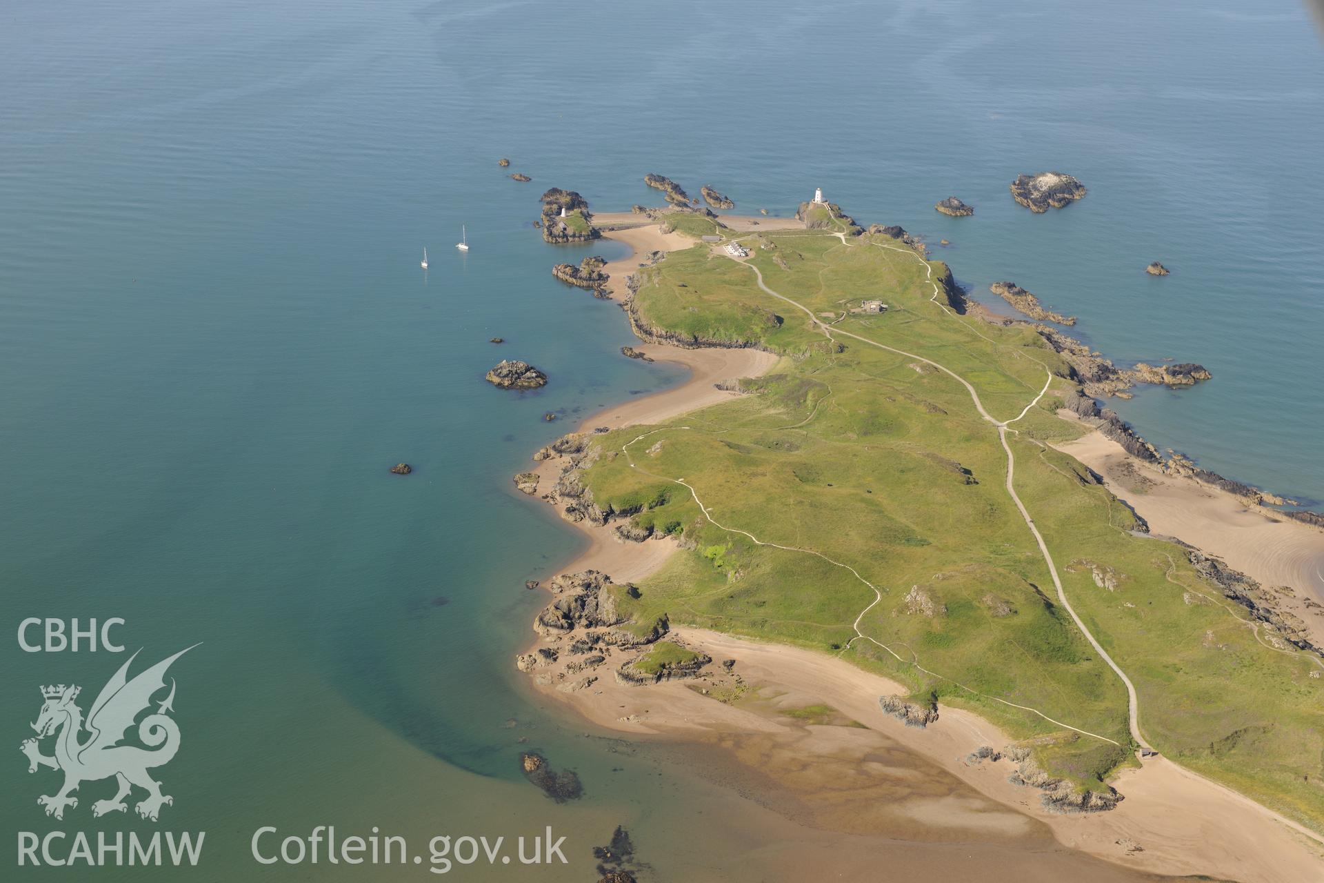 The lighthouse, tower, pilot's house and St. Dwynwen's Church on Llanddwyn Island. Oblique aerial photograph taken during the Royal Commission's programme of archaeological aerial reconnaissance by Toby Driver on 23rd June 2015.