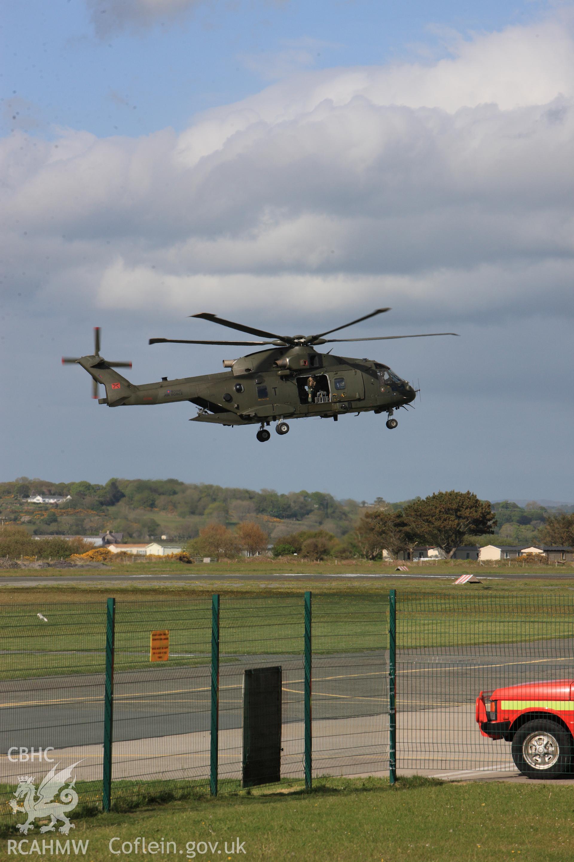 Royal Air Force Merlin landing at Caernarfon airfield. Oblique aerial photograph taken during the Royal Commission's programme of archaeological aerial reconnaissance by Toby Driver on 22nd May 2013.