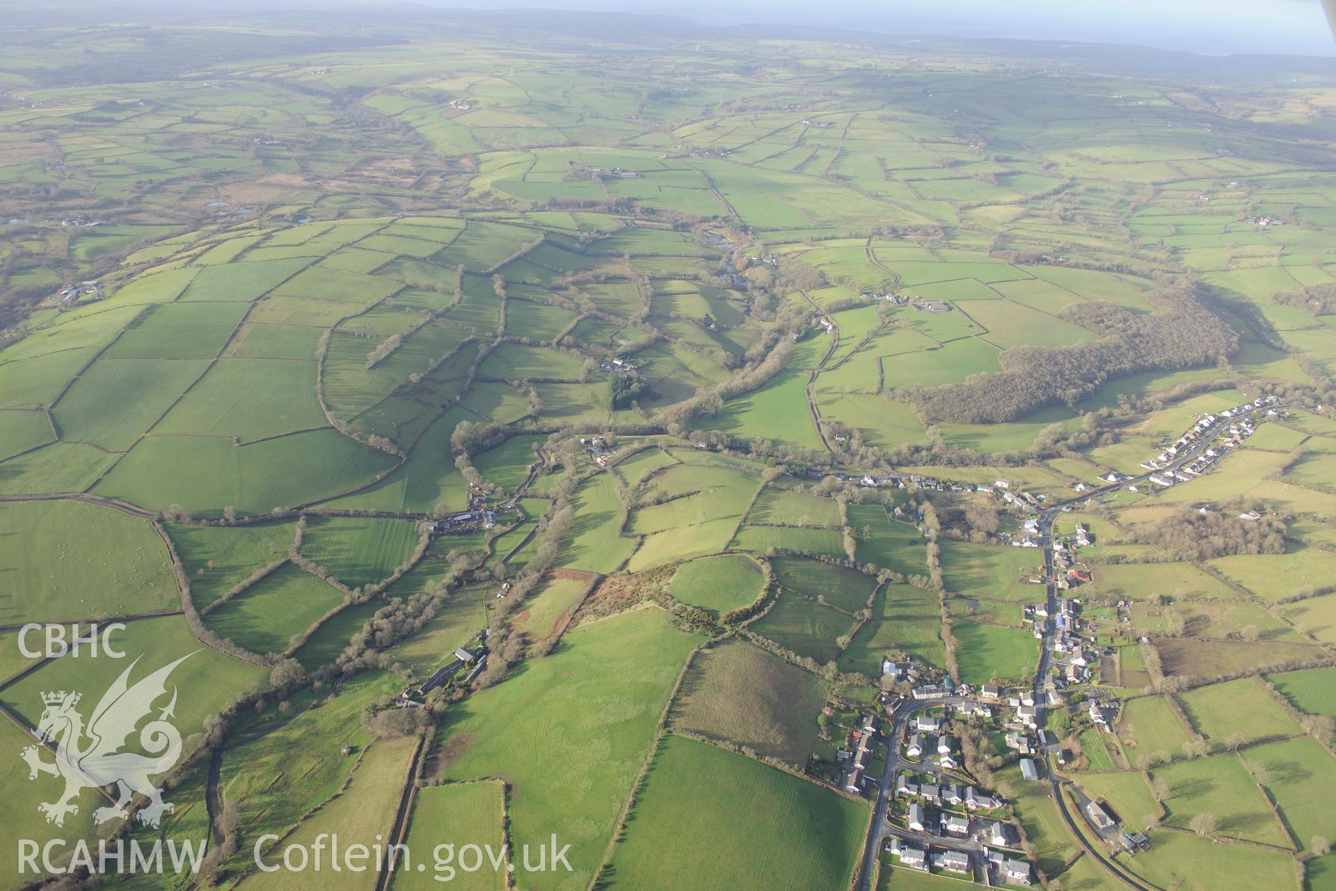 Cribyn village and Gaer Maesmynach hill fort. Oblique aerial photograph taken during the Royal Commission's programme of archaeological aerial reconnaissance by Toby Driver on 6th January 2015.