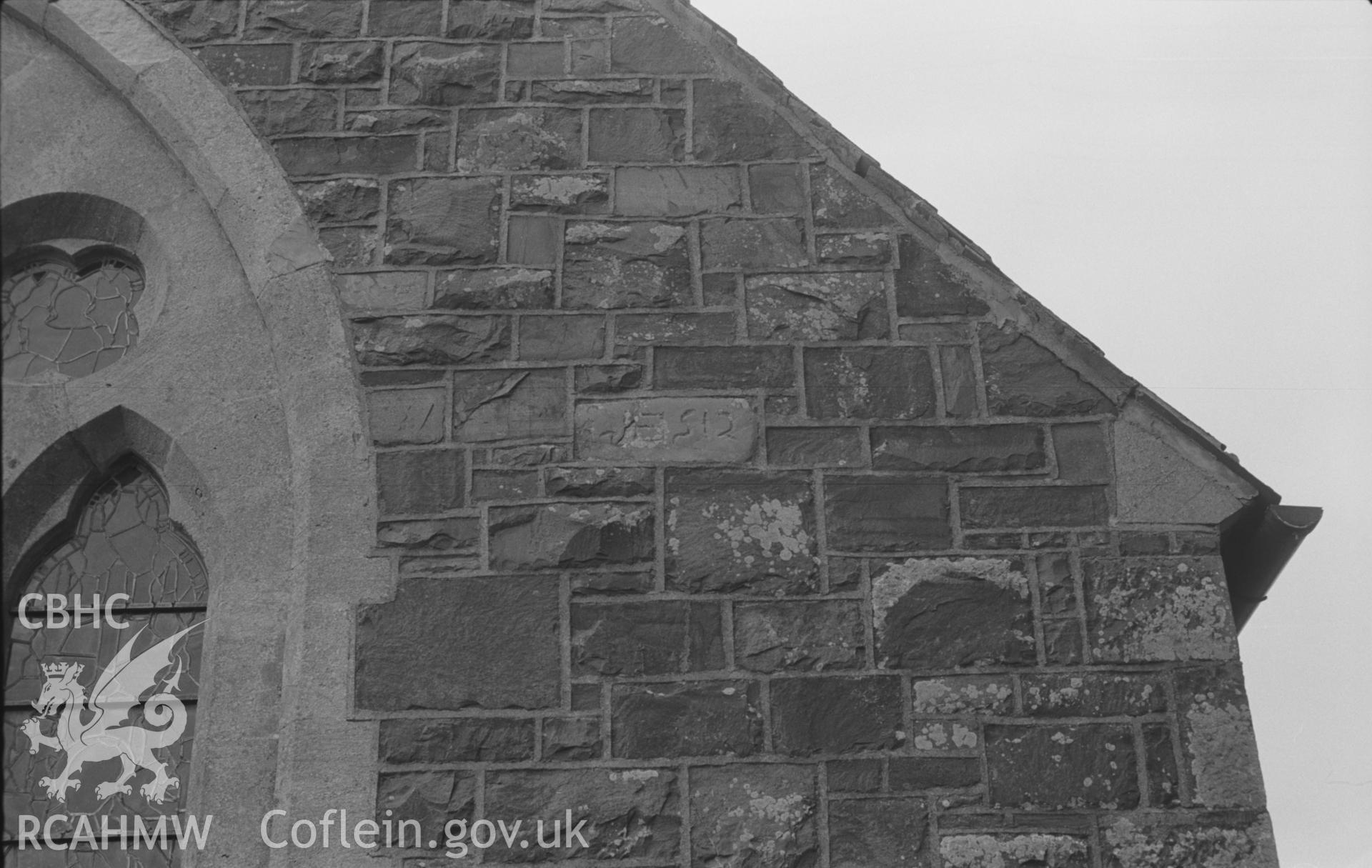 Digital copy of black & white negative showing 7th-9th century inscribed stone built into east wall of chancel at St. David's Church, Henfynyw. Photograph by Arthur Chater, 5th Sept 1966. 'TIGEI(?)R [N..., (... the stone) pf Tigernacus (?) (Nash-Williams)