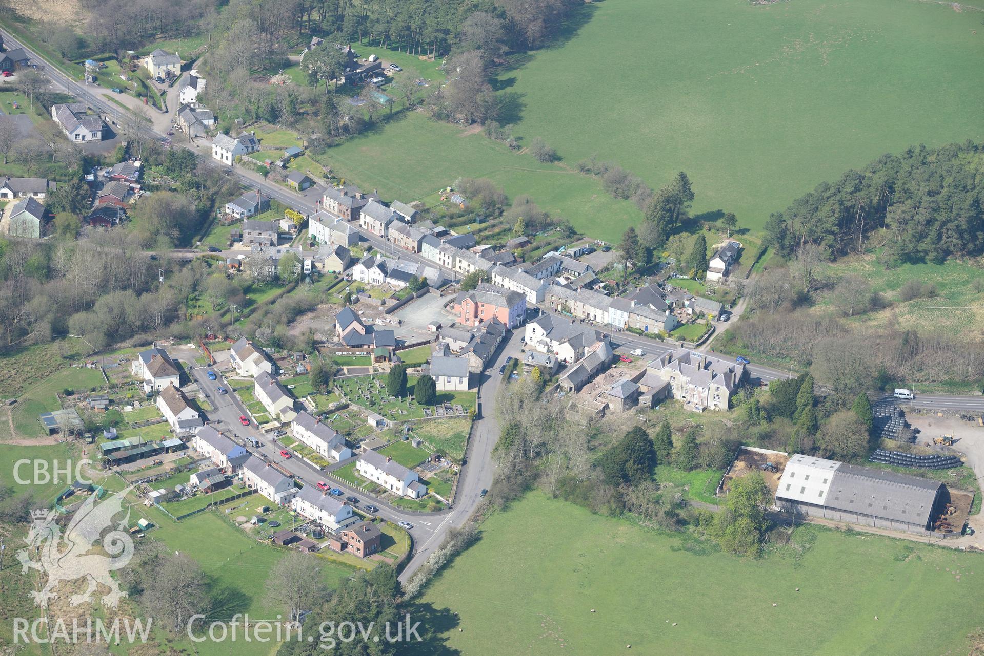 Trecastle Village, Castle House, Camden House, Methodist Chapel and Motte. Oblique aerial photograph taken during the Royal Commission's programme of archaeological aerial reconnaissance by Toby Driver on 21st April 2015