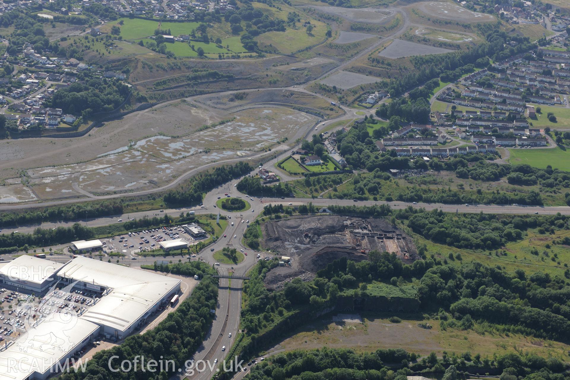 Site of former Rotax factory, Cyfarthfa Retail Park, and Cyfarthfa Ironworks including the remains of its blast furnaces, under excavation by Glamorgan-Gwent Archaeological Trust. Oblique aerial photograph taken during the Royal Commission?s programme of