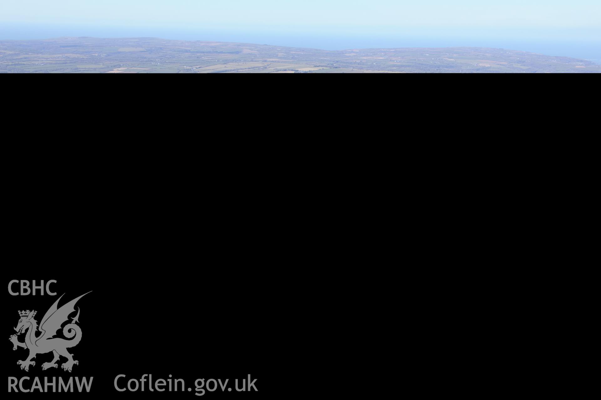 View of the round barrow on the eastern spur of Frenni Fawr, with a cairn cemetery beyond, in the centre of the photograph. Oblique aerial photograph taken during the Royal Commission's programme of archaeological aerial reconnaissance by Toby Driver on 2nd April 2013.