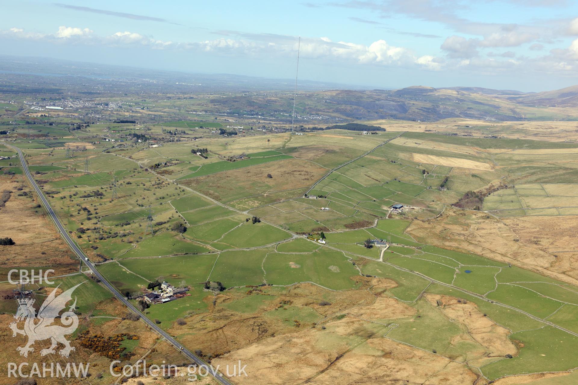 Caerau Iron age settlement, Caerau field system and Caerau settlement IV, south of Caernarfon. Oblique aerial photograph taken during the Royal Commission?s programme of archaeological aerial reconnaissance by Toby Driver on 1st May 2013.