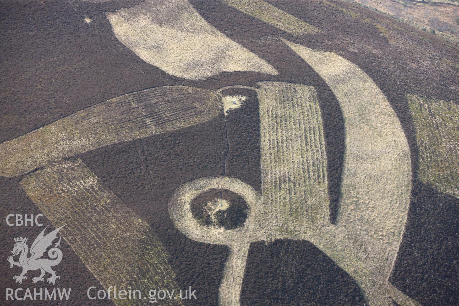 Moel Gyw barrow, east of Ruthin. Oblique aerial photograph taken during the Royal Commission?s programme of archaeological aerial reconnaissance by Toby Driver on 28th February 2013.