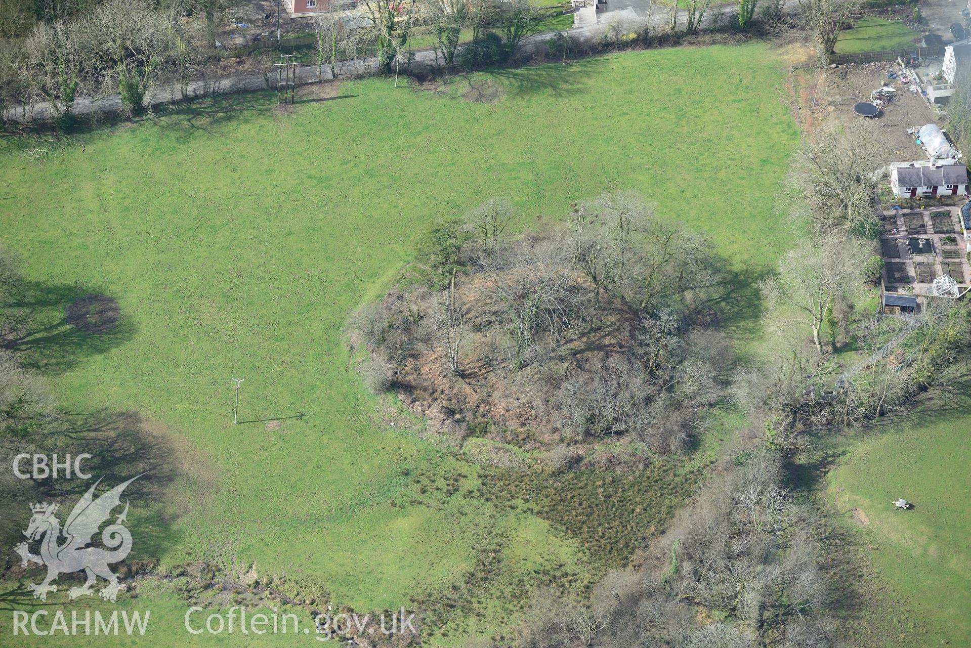 New Moat Castle motte and bailey, New Moat, near Haverfordwest. Oblique aerial photograph taken during the Royal Commission's programme of archaeological aerial reconnaissance by Toby Driver on 13th March 2015.