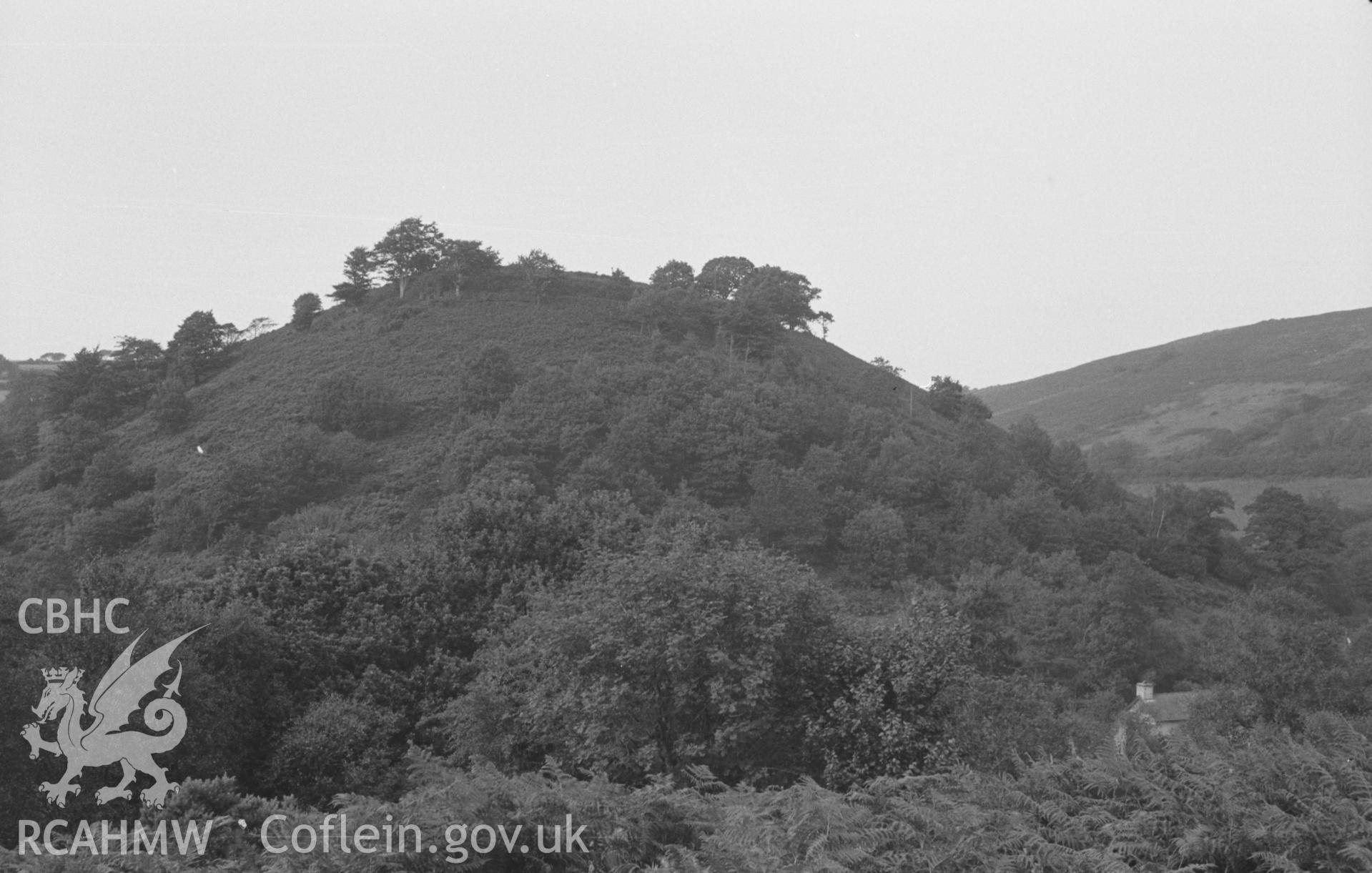 Digital copy of a black and white negative showing view of Dinas Cerdin hillfort, Troedyraur. Photographed by Arthur O. Chater in August 1965 from the footpath below the road to the south at Grid Reference SN 385 466, looking north.