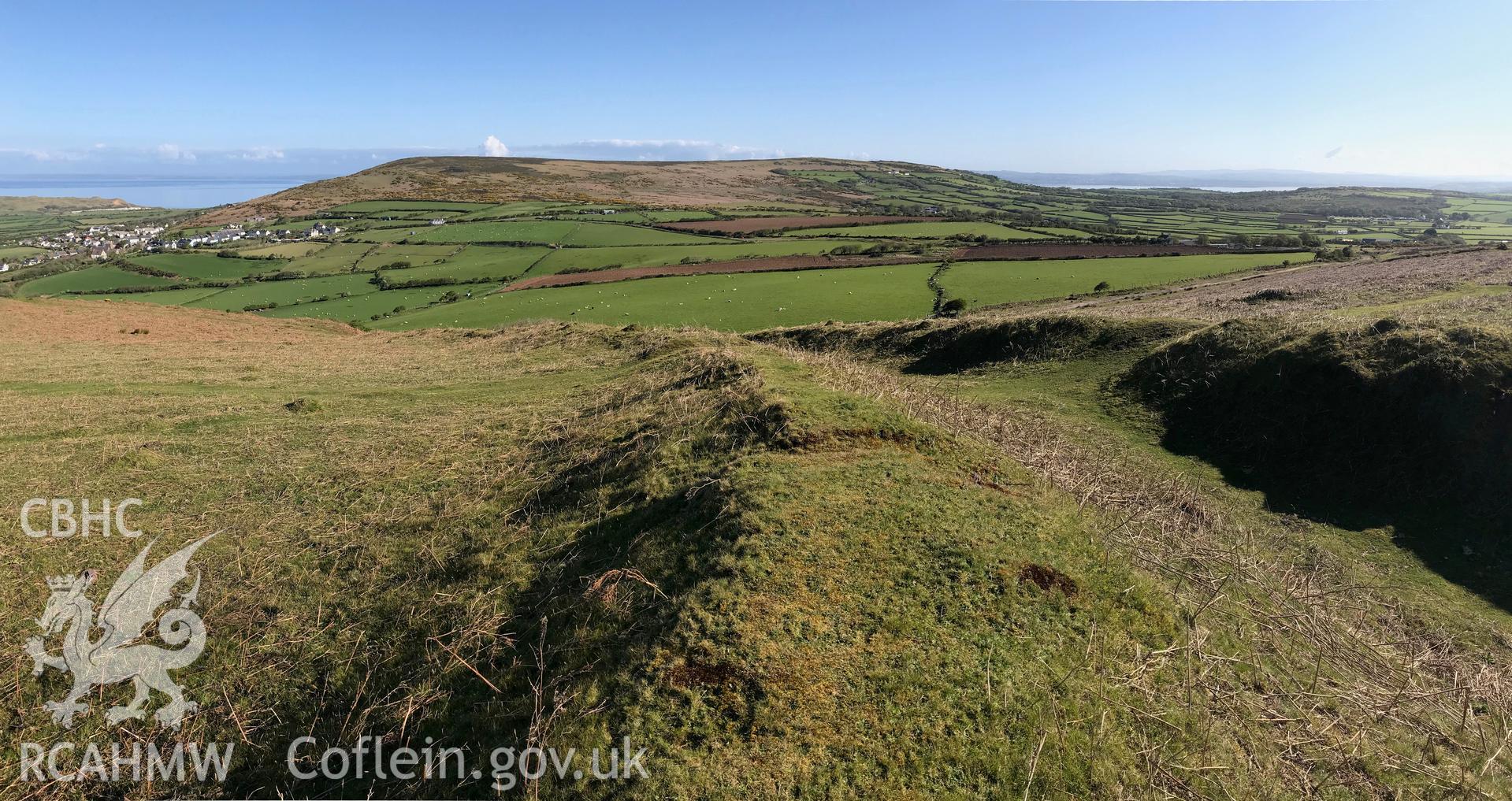 Digital colour photograph showing panoramic view of Hardings Down West Fort, Llangennith, looking westwards towards the sea, taken by Paul R. Davis on 5th May 2019.