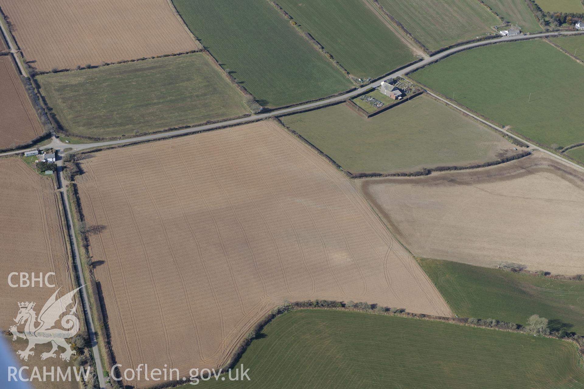 Penuel Welsh Baptist church at Rhyd-y-Maen, and the Post-Goch south round barrow pair in adjacent field, near Nevern. Oblique aerial photograph taken during the Royal Commission's programme of archaeological aerial reconnaissance by Toby Driver on 2nd April 2013.