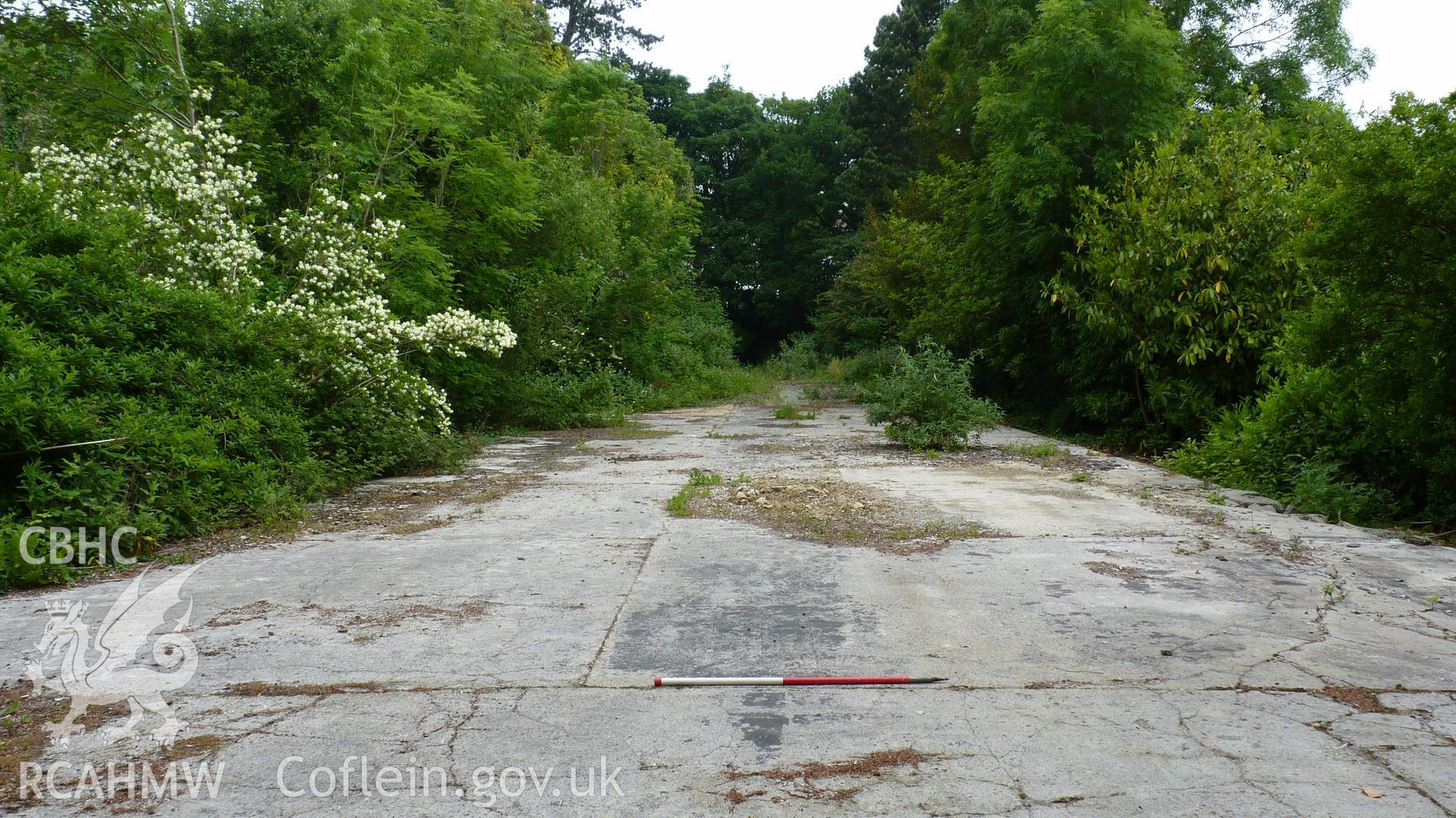 'View north along the footings of the former modern RTB and Library building to the east of the main house. 1m scale.' Photographed as part of archaeological work at Coed Parc, Newcastle, Bridgend, carried out by Archaeology Wales, 2016. Project no. P2432.