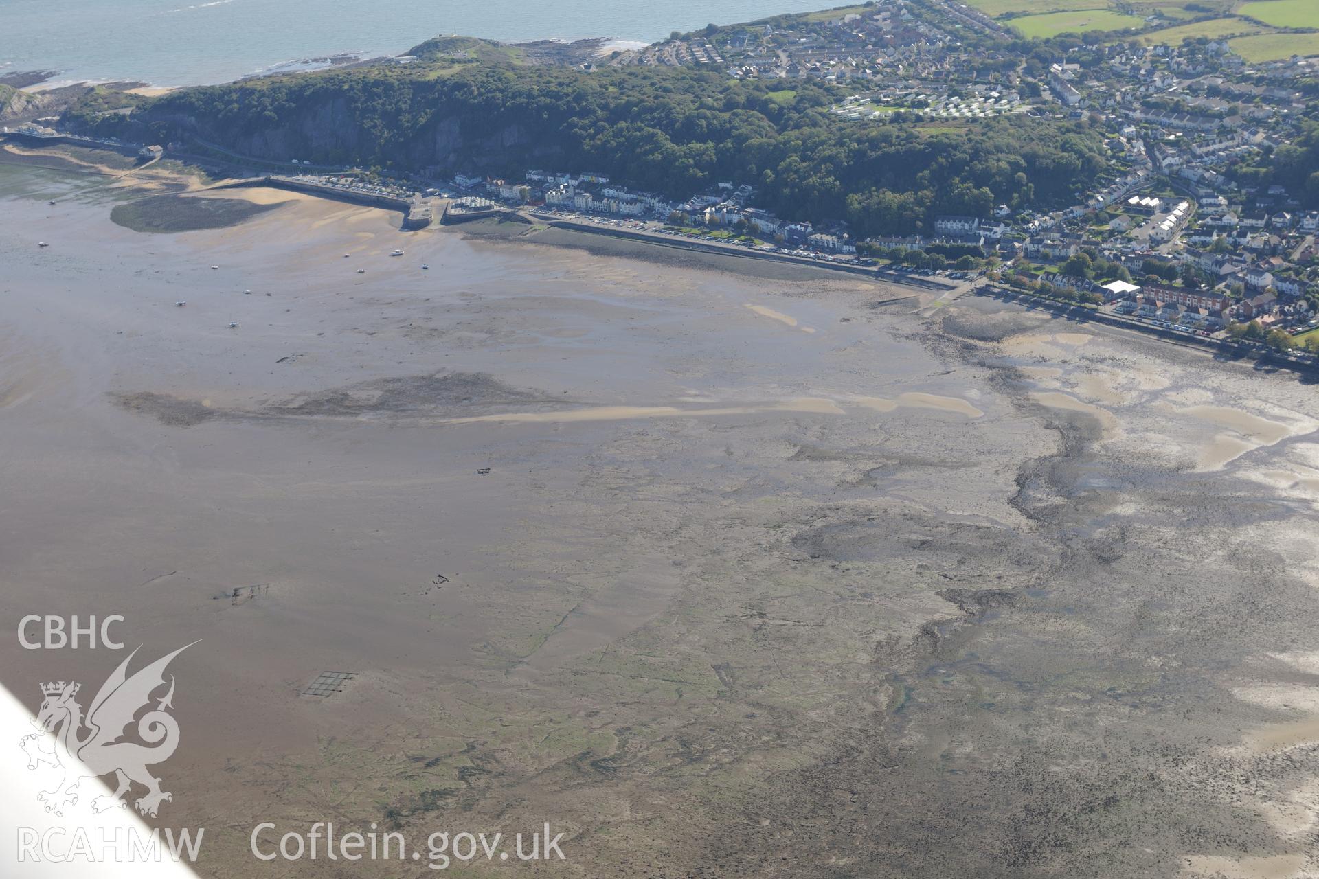 Landing place on Mumbles foreshore with the Mumbles and Swansea Bay beyond. Oblique aerial photograph taken during the Royal Commission's programme of archaeological aerial reconnaissance by Toby Driver on 30th September 2015.