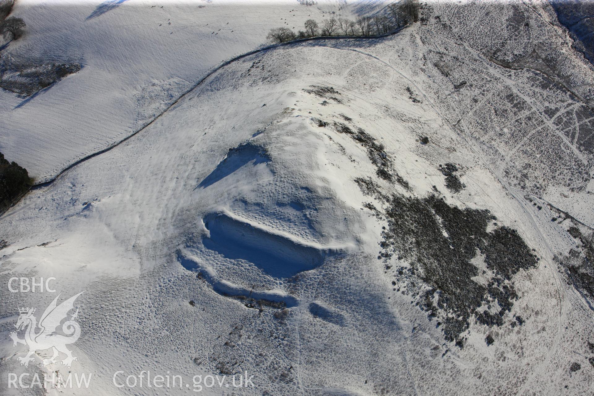 Cwm Berwyn defended enclosure and hut platform, Glascwm, north east of Builth Wells. Oblique aerial photograph taken during the Royal Commission?s programme of archaeological aerial reconnaissance by Toby Driver on 15th January 2013.