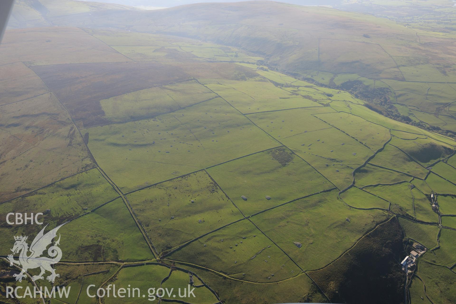 View from the west of Parth-y-Gwddwch homestead and Gwastadgoed cairns and standing stones, near Llwyngwril. Oblique aerial photograph taken during the Royal Commission's programme of archaeological aerial reconnaissance by Toby Driver on 2nd October 2015.