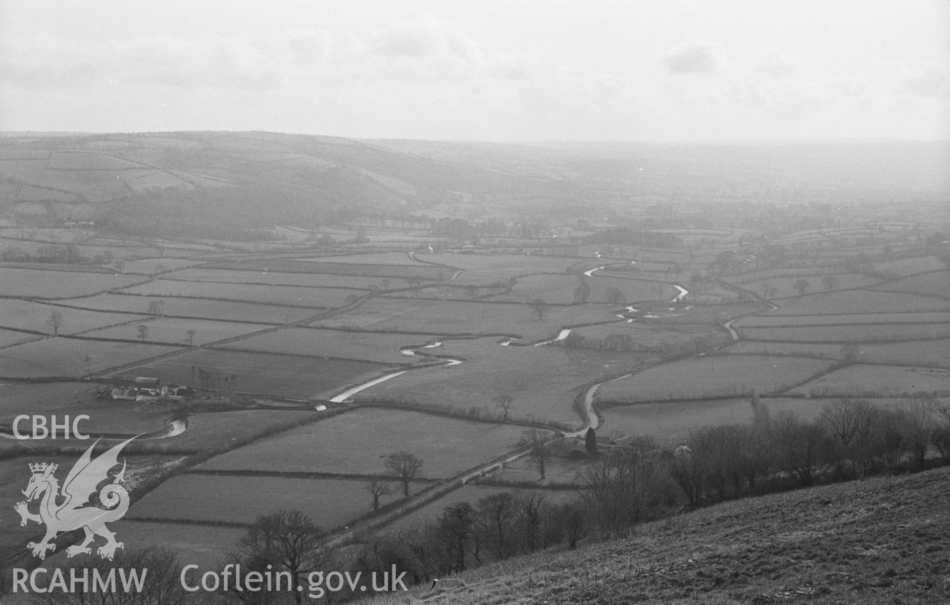 Black & White photograph showing view from Pen-y-Gaer, Nantcwnlle, down Aeron Valley to Llundain-fach and Aber-Meurig. Tre-fran and Pont Tre-Fran on the right. Photographed by Arthur Chater in April 1963 from Grid Reference SN 577 583, looking south west.