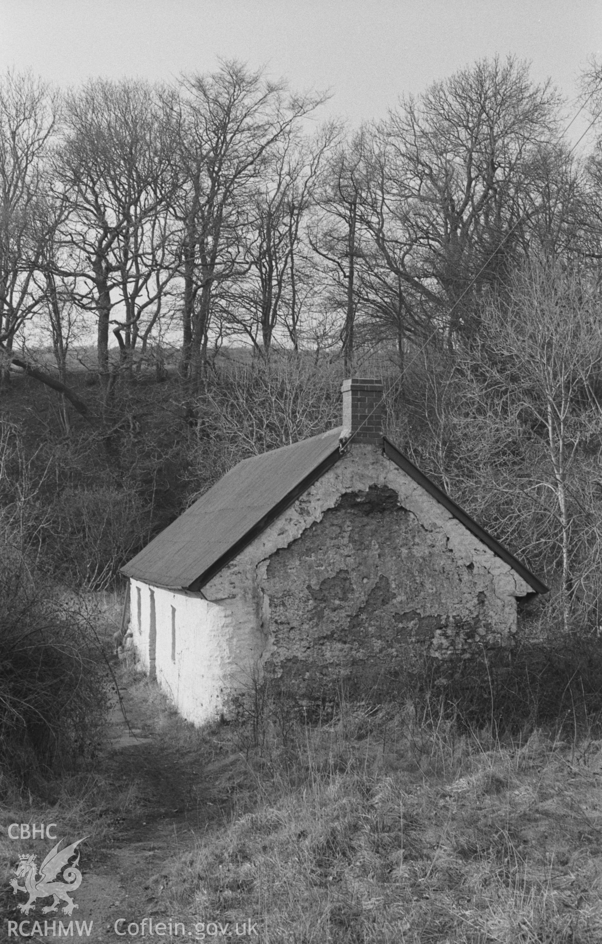 Black and White photograph showing mud-walled cottage on the south side of the stream 100m below Llwyndafydd bridge. Photographed by Arthur Chater in April 1963 from Grid Reference SN 369 555, looking north.