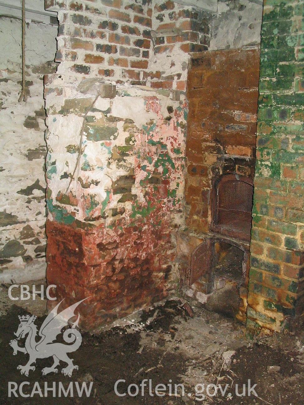 Dwelling end of Allt Ddu farmhouse, dwelling interior, chimney breast of main fireplace, entrance passage behind.