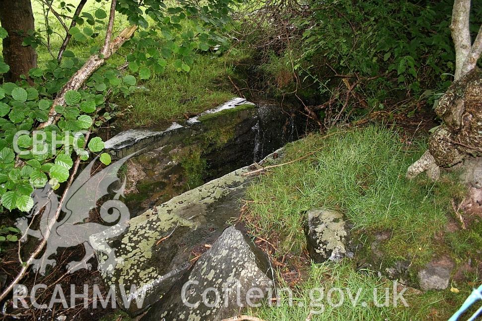 Downhouse end of Allt Ddu farmhouse, wheel pit in minor watercourse to west.